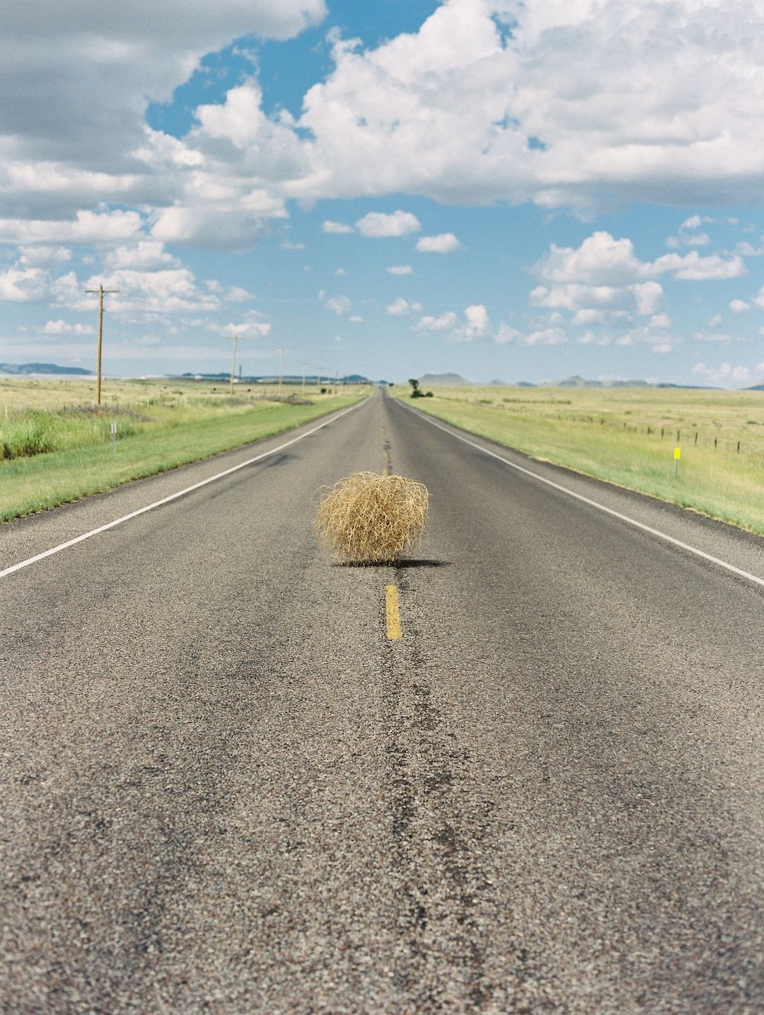 1080x1434 Vertical Photo of Tumbleweed Rolling Across West Texas Road. West Texas Blue Sky With Clouds. West Texas Road. West Texas Landscape