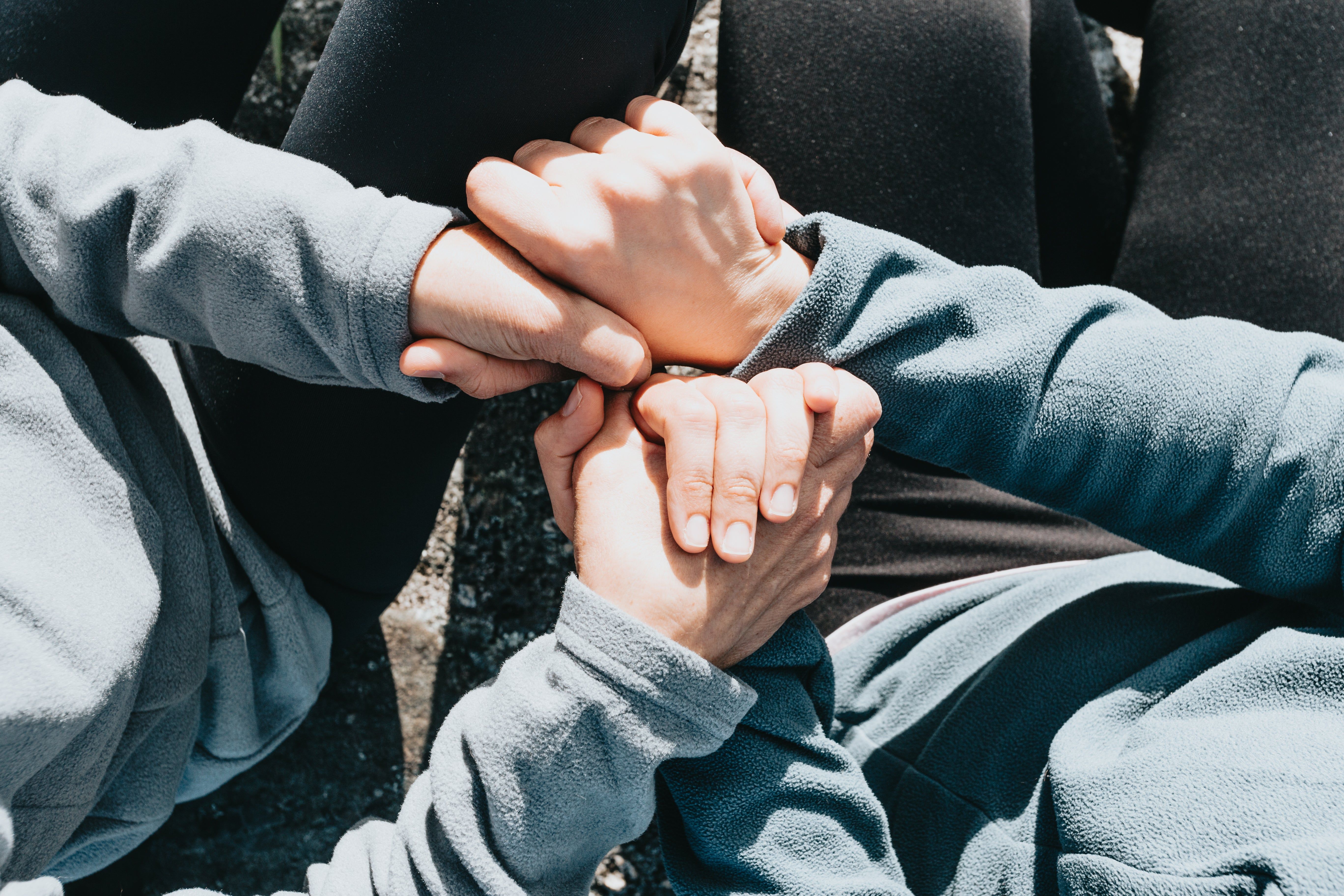 5472x3648 Browse Free HD Image of Looking Down Toward People Holding Hands And Sitting