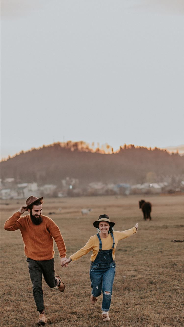 750x1334 man holdind woman hand iPhone 8 Wallpaper Free Download