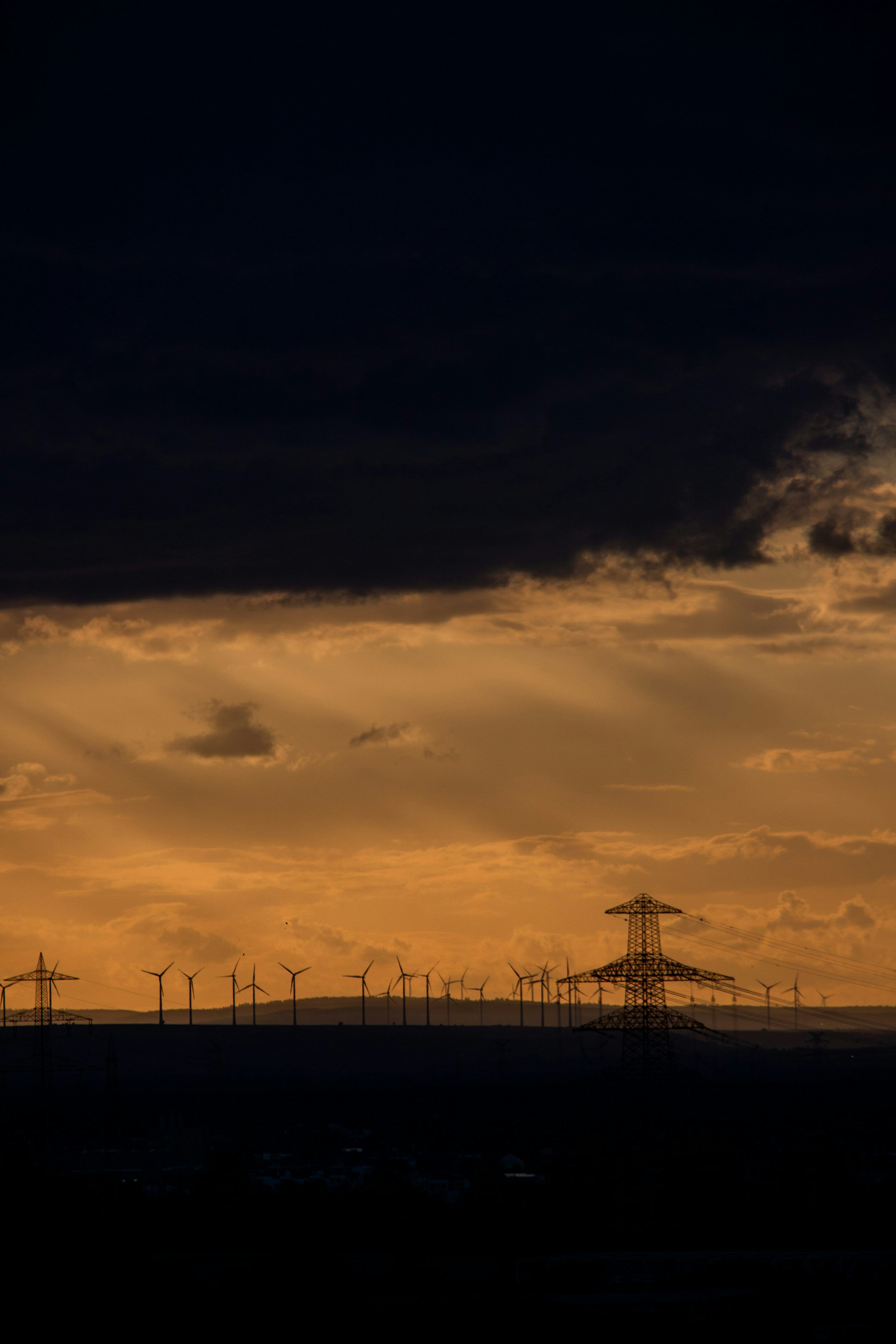 3000x4499 Wind turbines and pylons at dusk