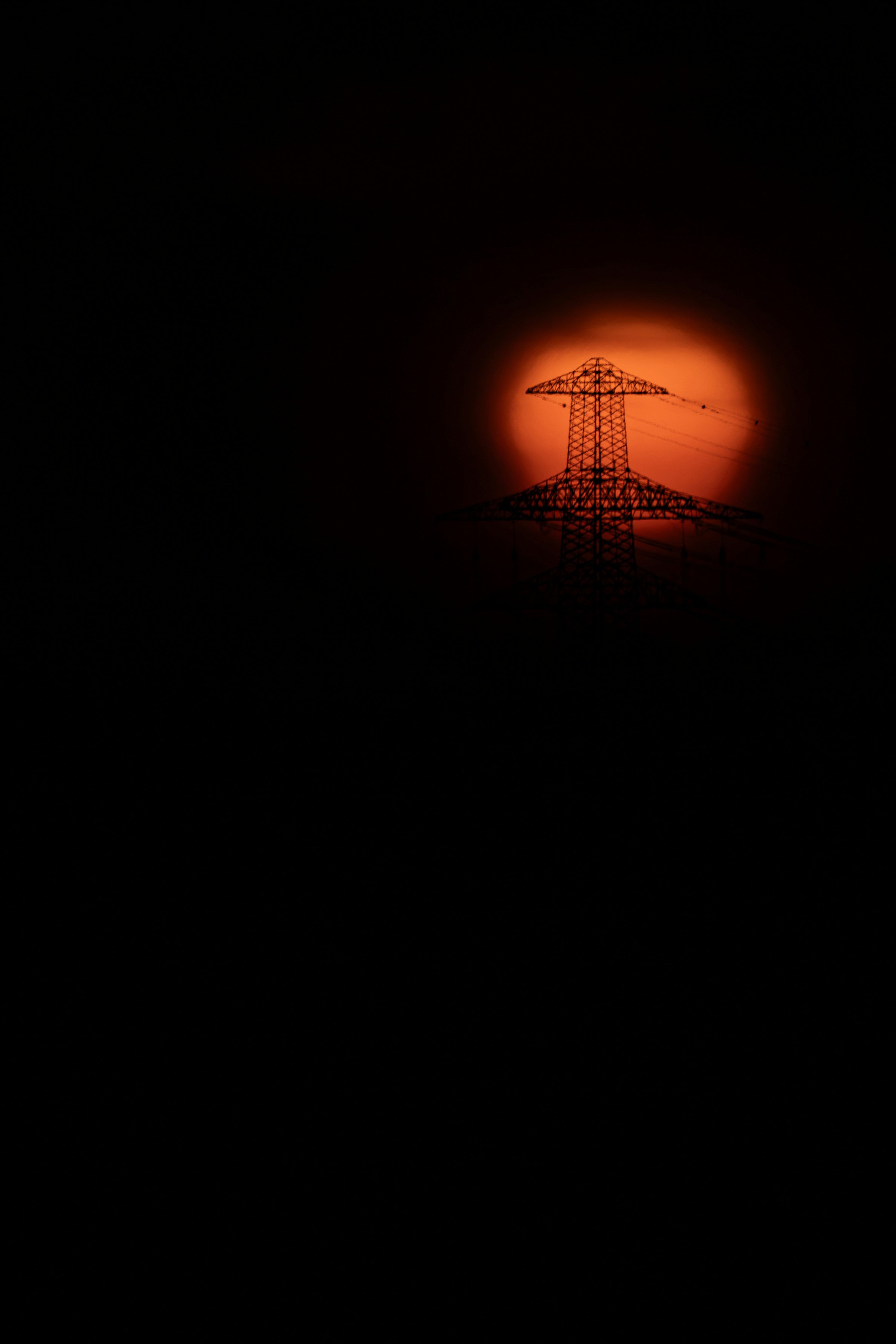 3000x4501 Electricity pylon silhouette against sun