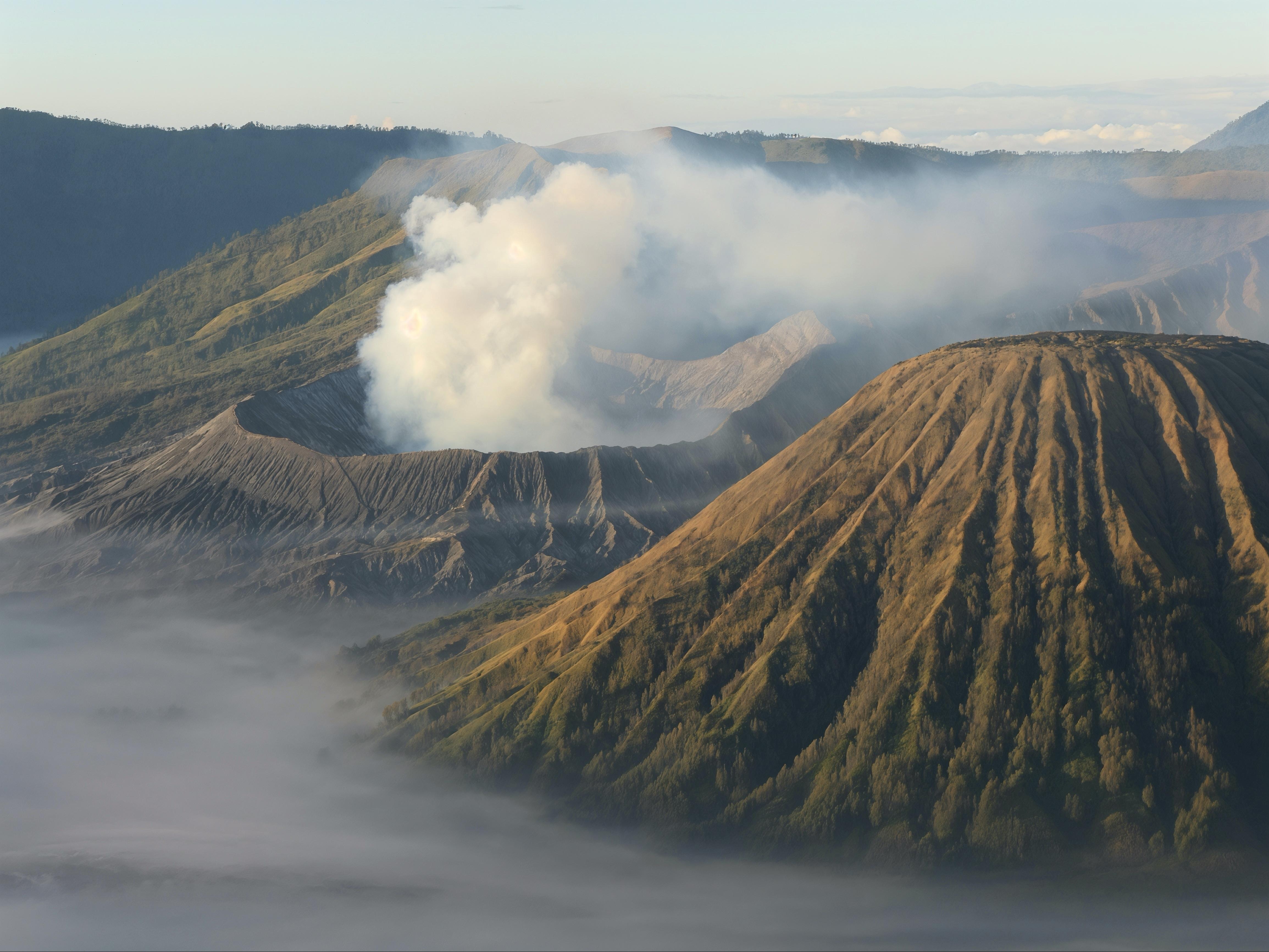 4618x3464 Don't think I'll ever get a better spot than that! Mt Bromo and Mt Semeru erupting at the same time, golden sunrise lighting, and a cloud inversion in the caldera [Java, Indonesia]