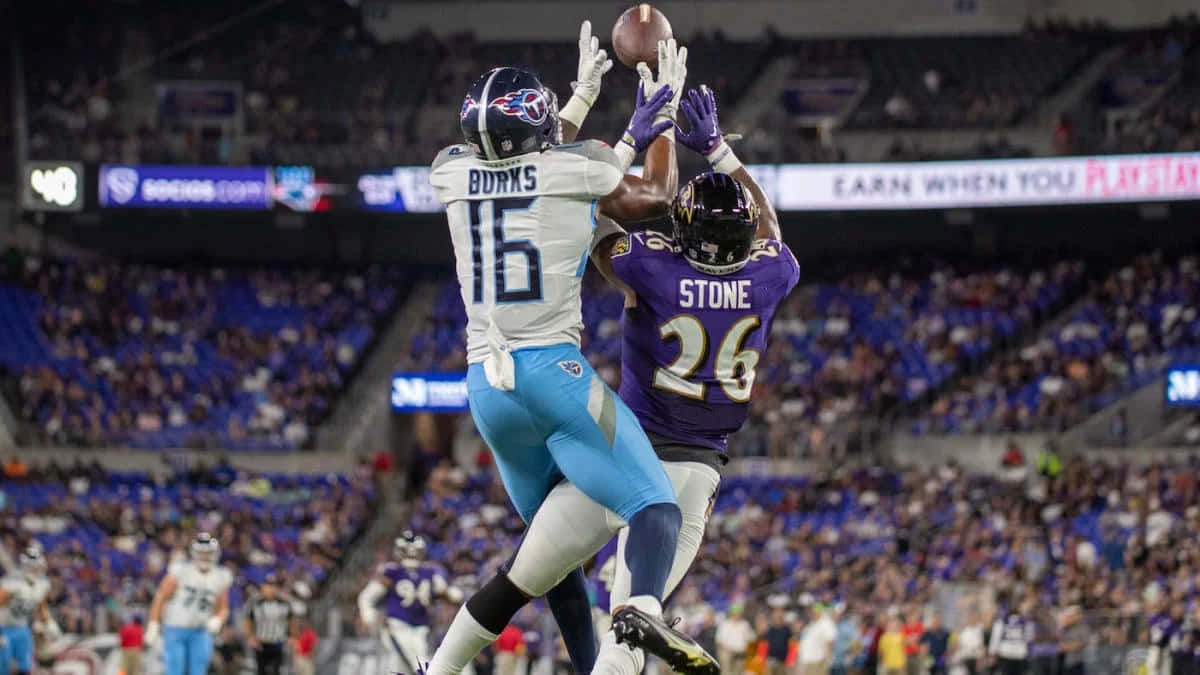 1200x675 Download Treylon Burks Catching Football Against Defender Wallpaper