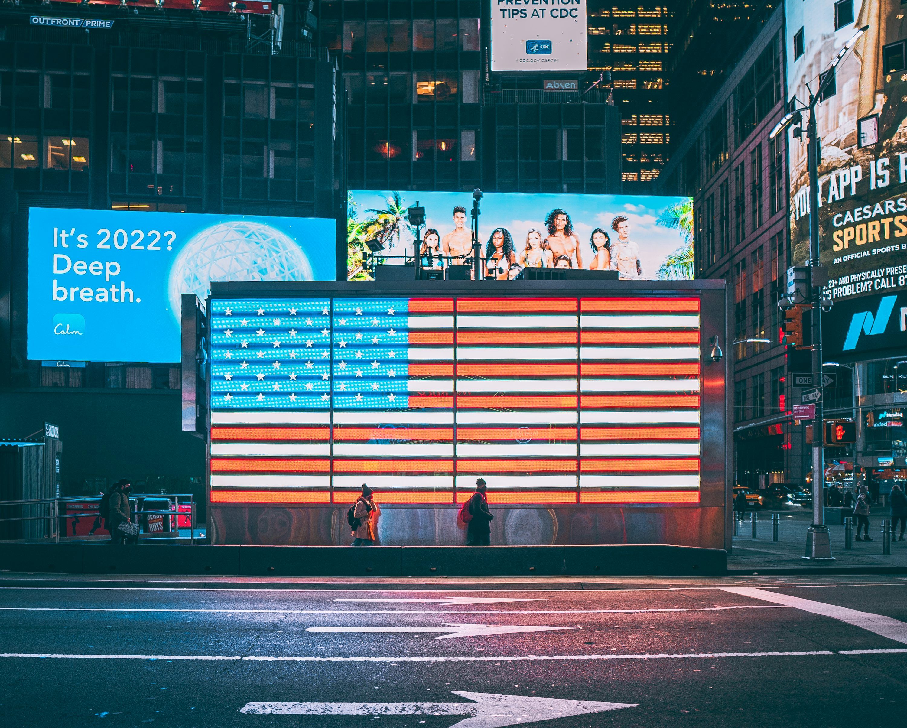 3000x2408 An american flag is projected on a billboard in times square
