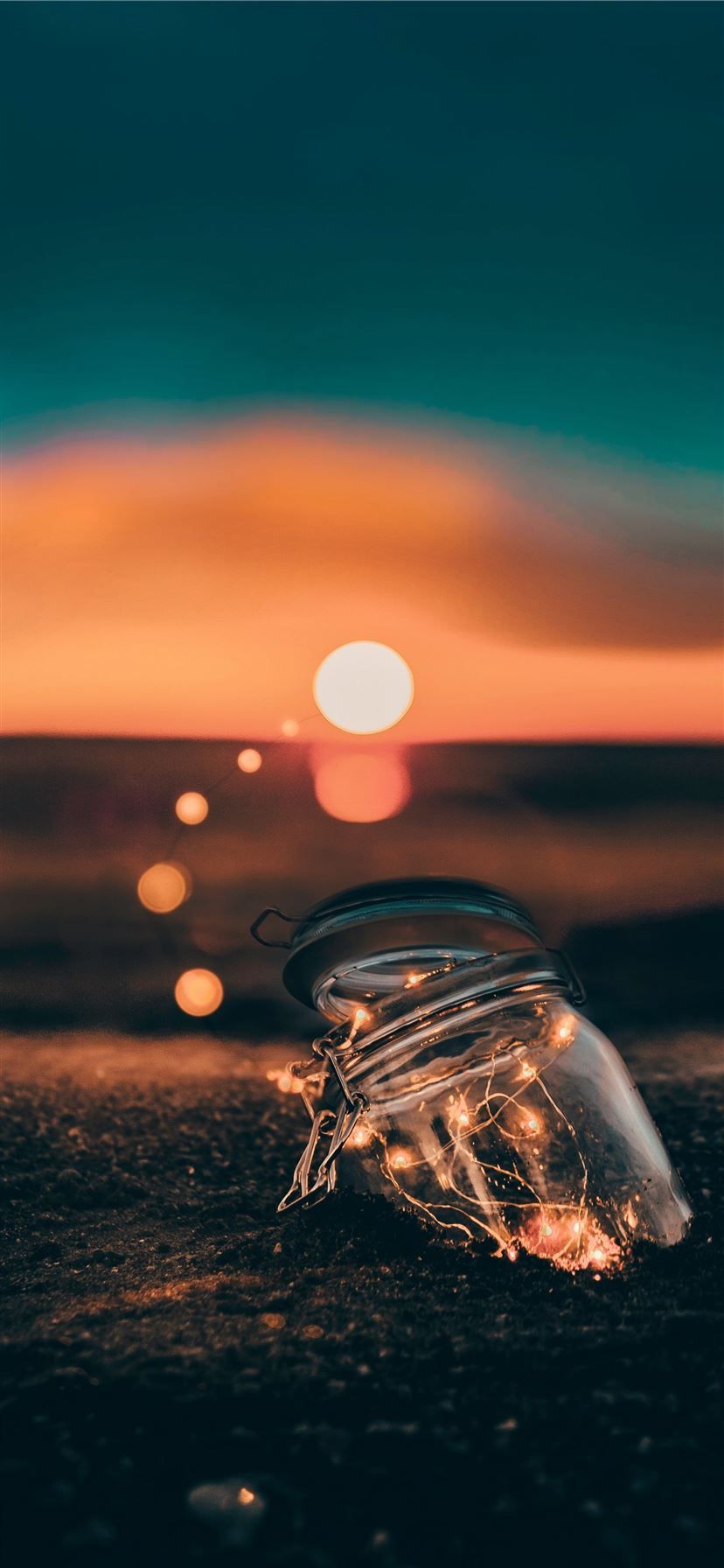 828x1792 clear glass jar on sand iPhone 11 Wallpaper Free Download