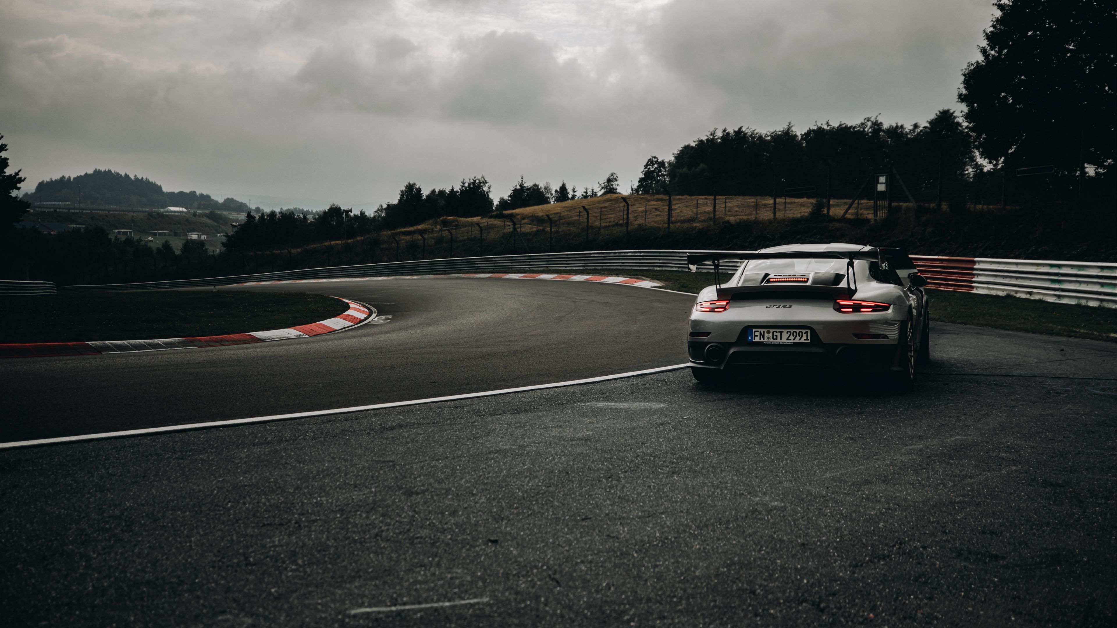 3840x2160 Download wallpaper 3840x2160 porsche 911 gt2 rs, porsche, car, sports car, gray, rear view, track 4k uhd 16:9 HD background