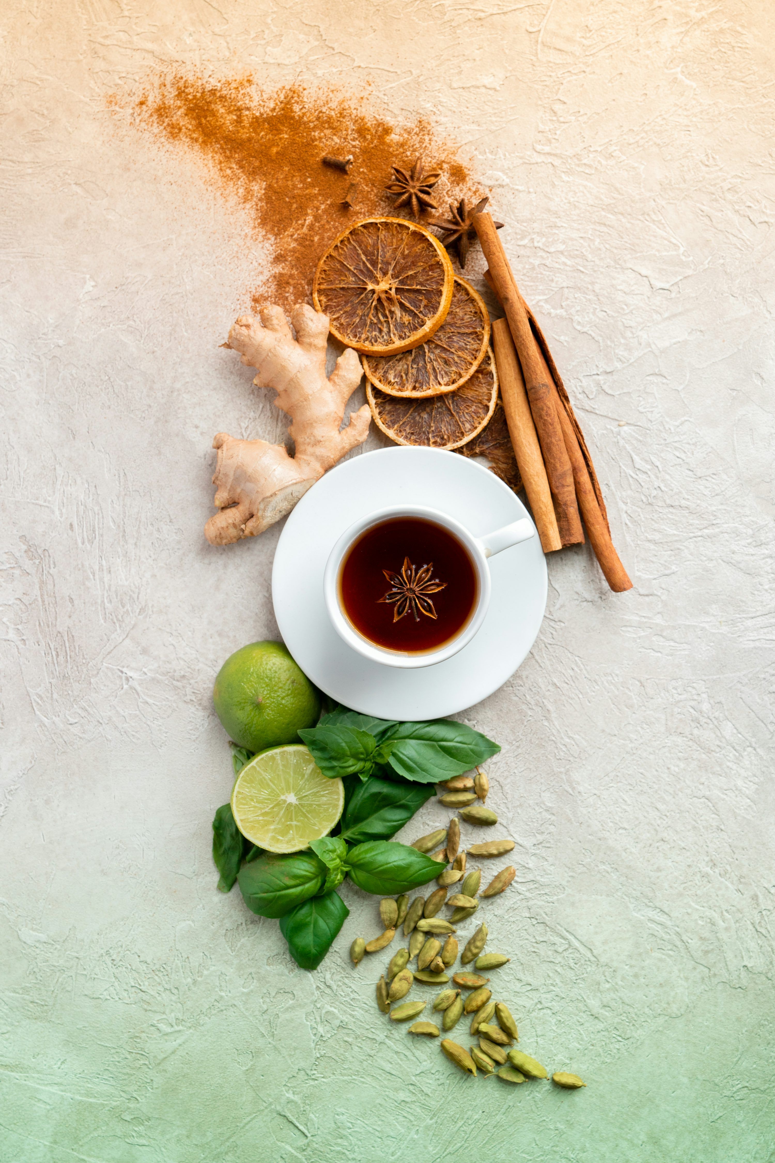 3000x4500 A cup of tea next to cinnamon, limes, limes and cinnamon sticks photo