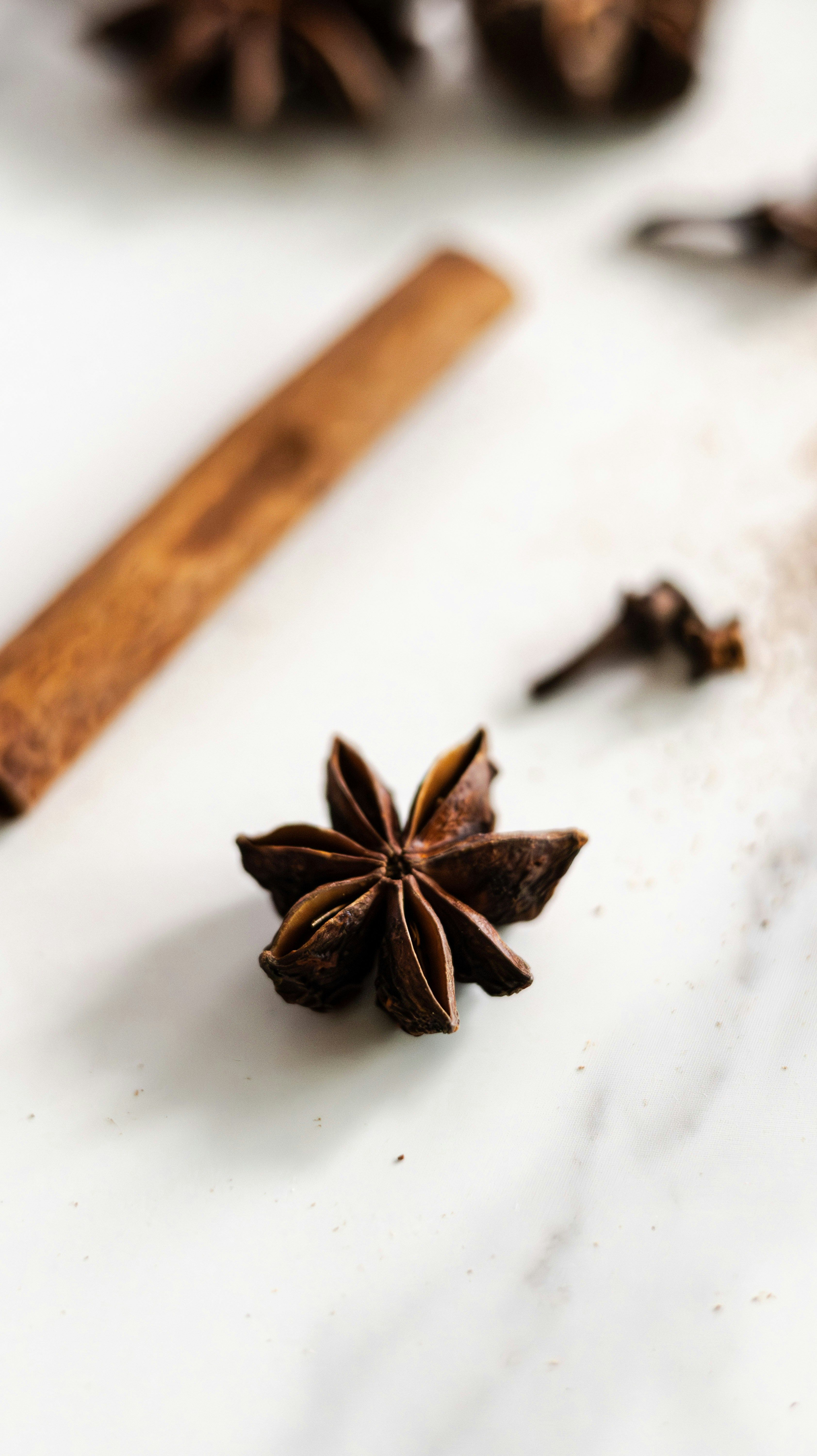 3368x6000 Cinnamon sticks and star anise on a white background