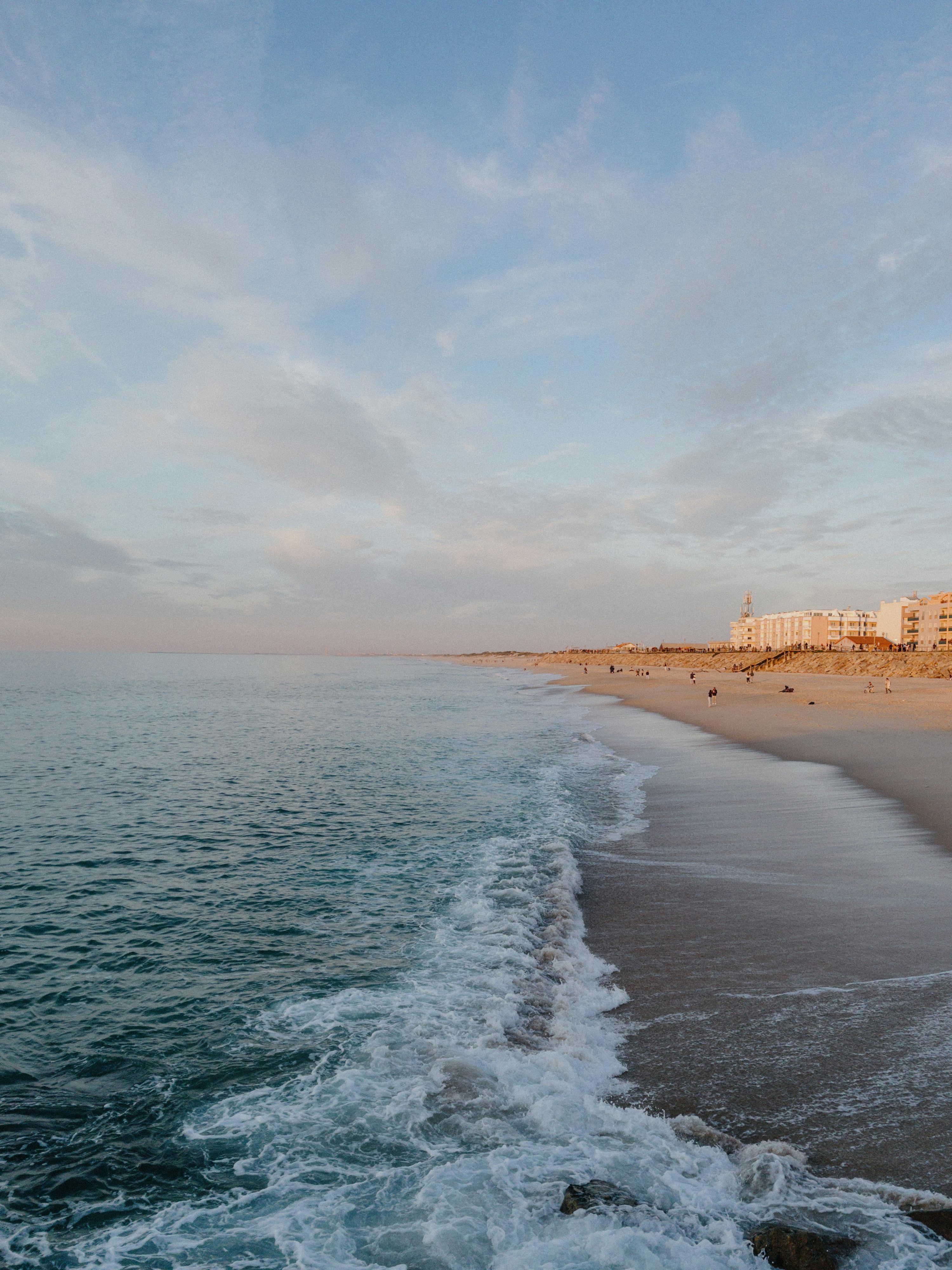3000x4000 A view of a beach with a building in the background