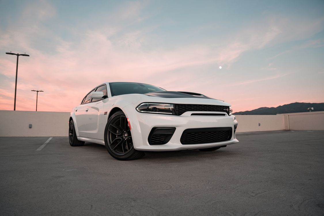 1125x750 White Dodge Charger SRT Hellcat Widebody on the Top Floor of the Parking Garage at Dusk · Free