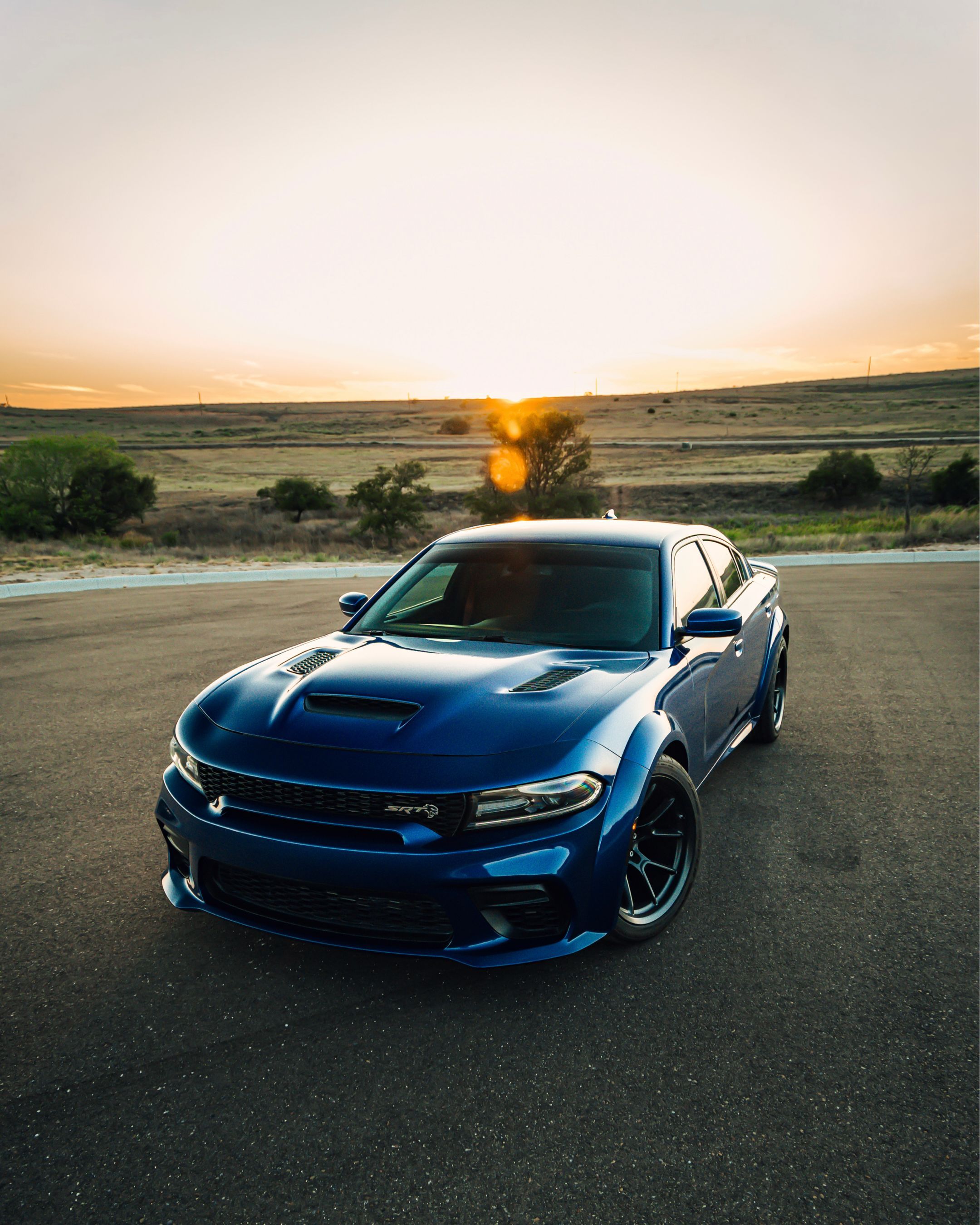 2160x2700 White Dodge Charger SRT Hellcat Widebody on the Top Floor of the Parking Garage at Dusk · Free