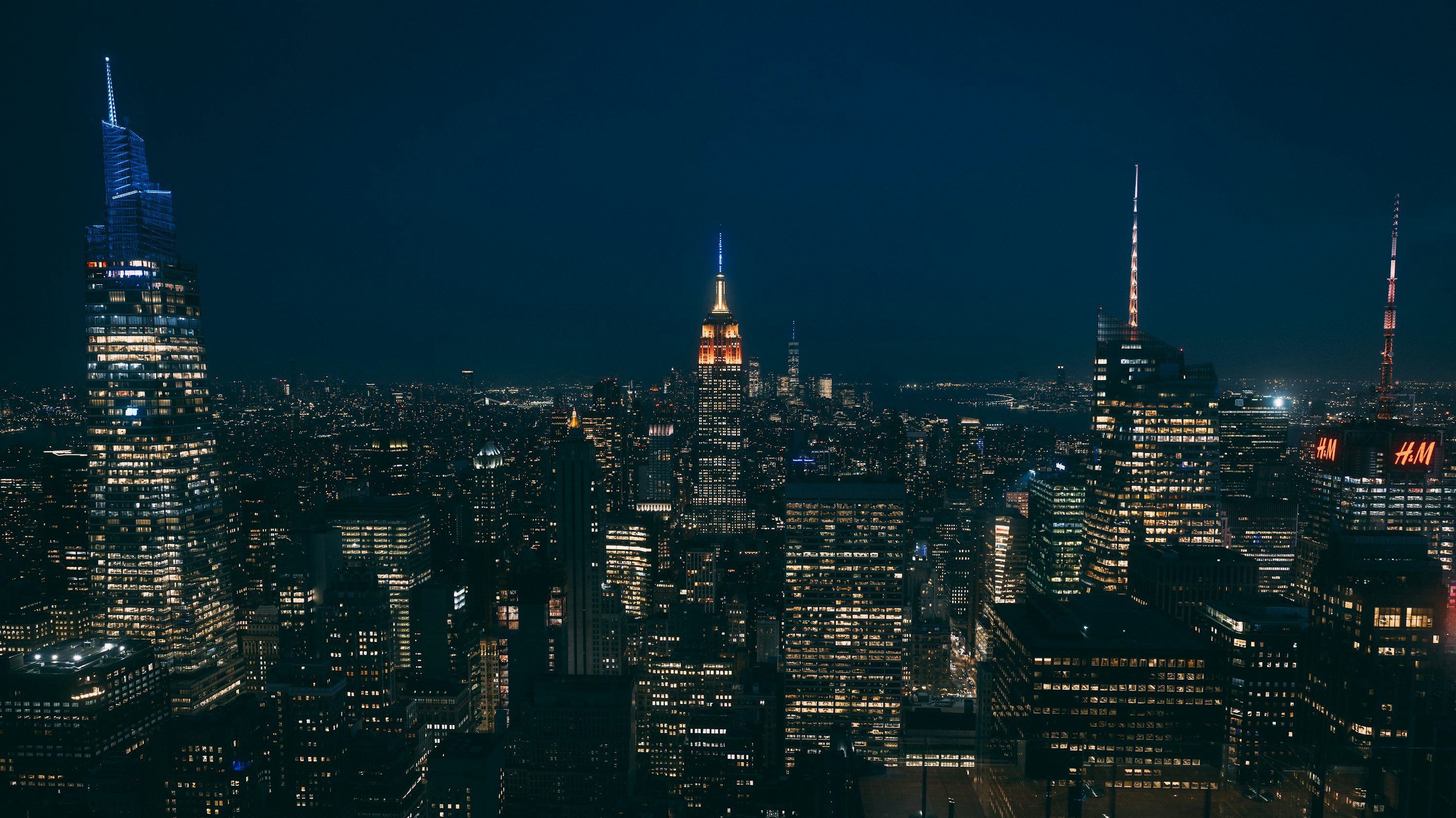 3000x1687 A view of a city at night from the top of a building