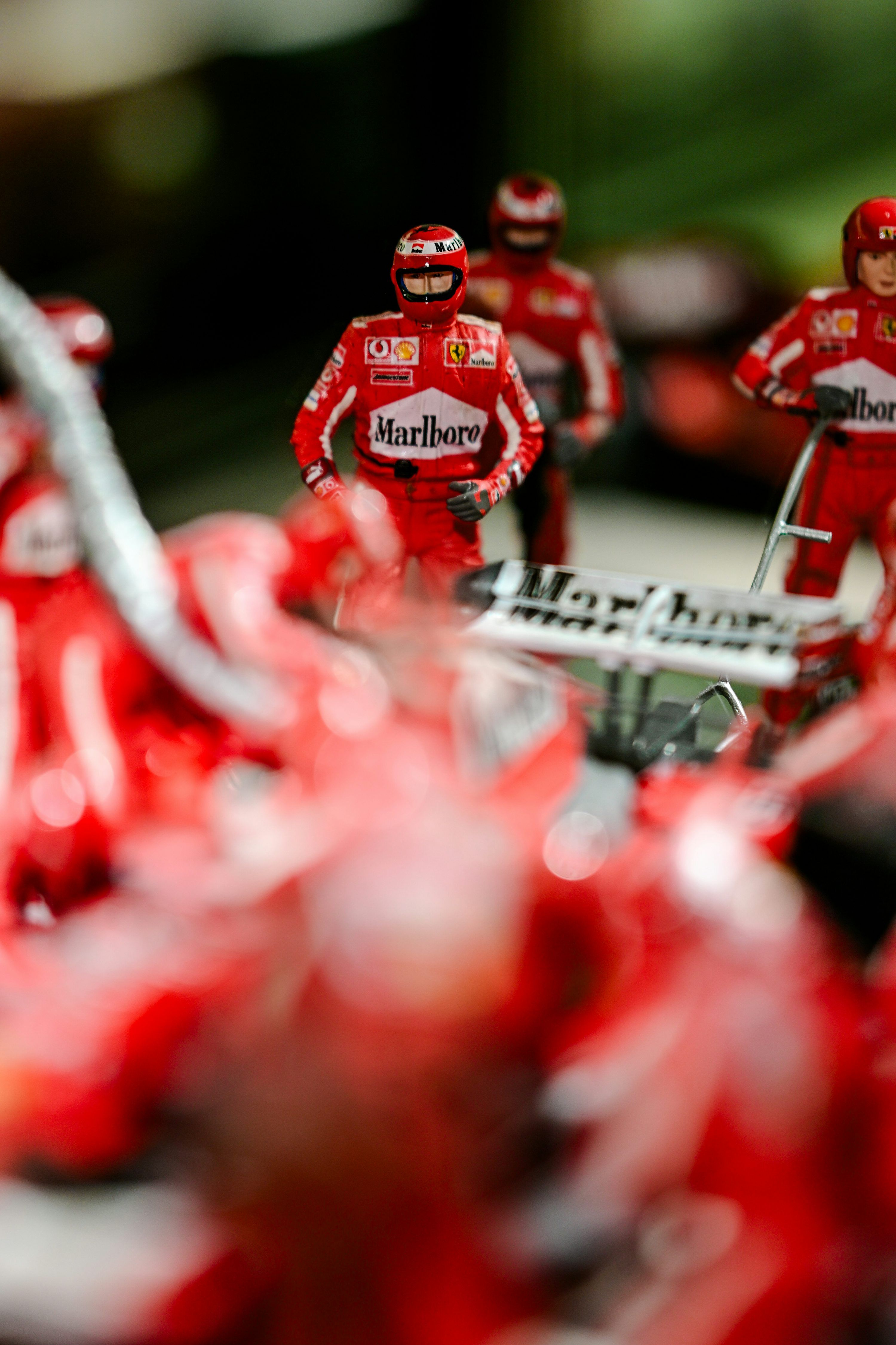 3000x4500 Miniature red formula 1 racing driver figures