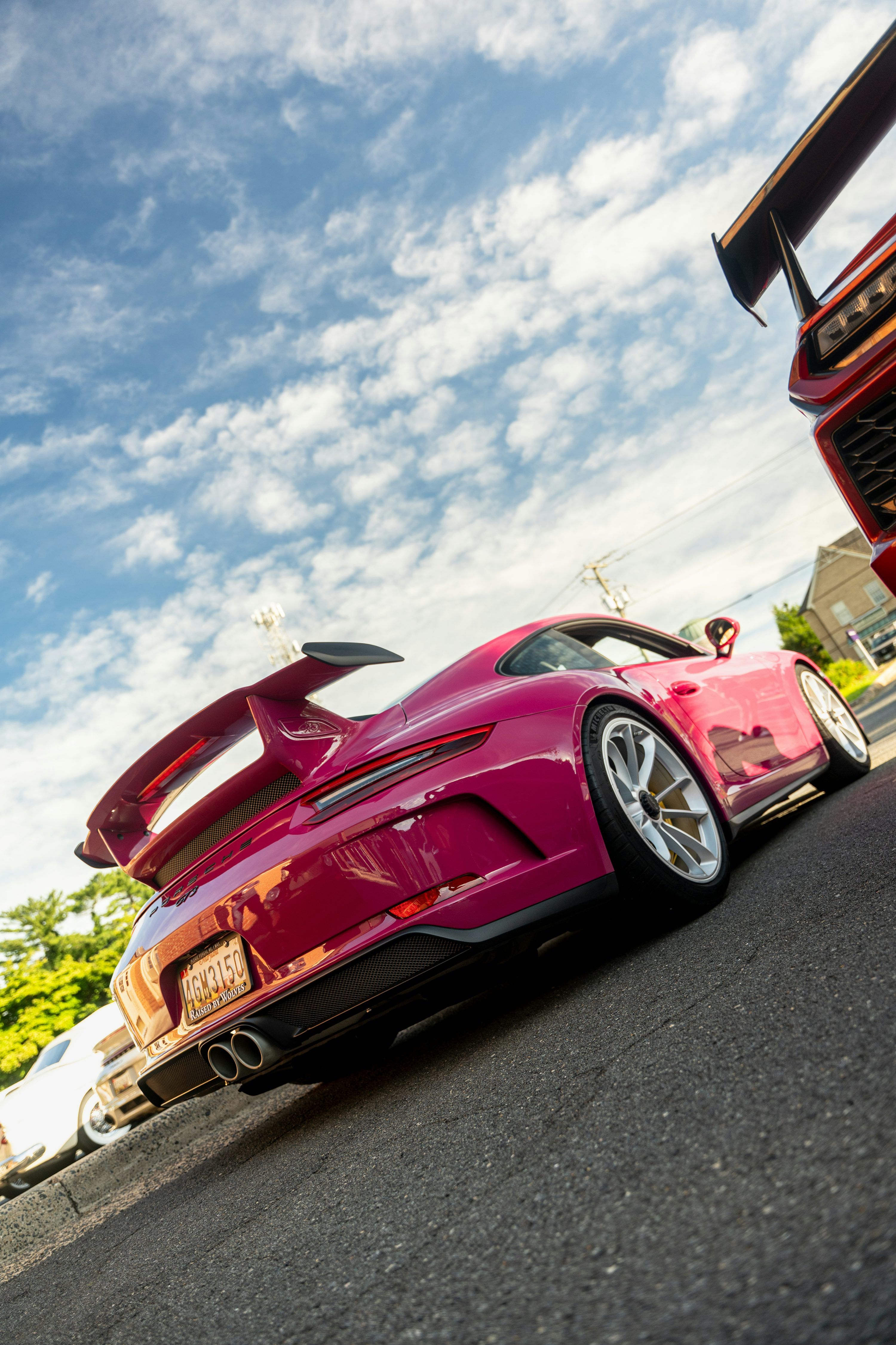 3000x4500 Pink sports car with large spoiler parked on asphalt