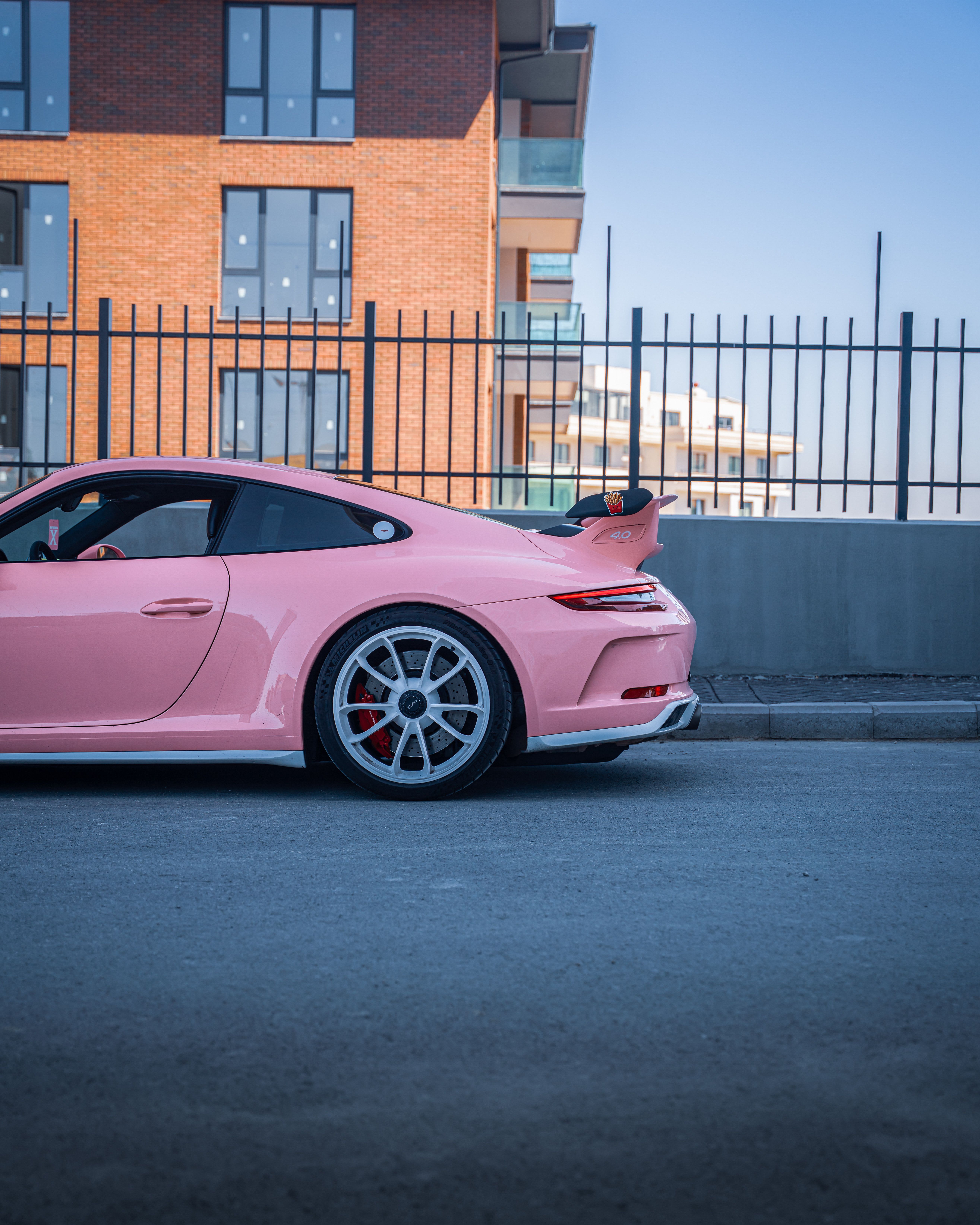 5259x6574 Vibrant Pink Sports Car Parked Street Side in Dubai · Free