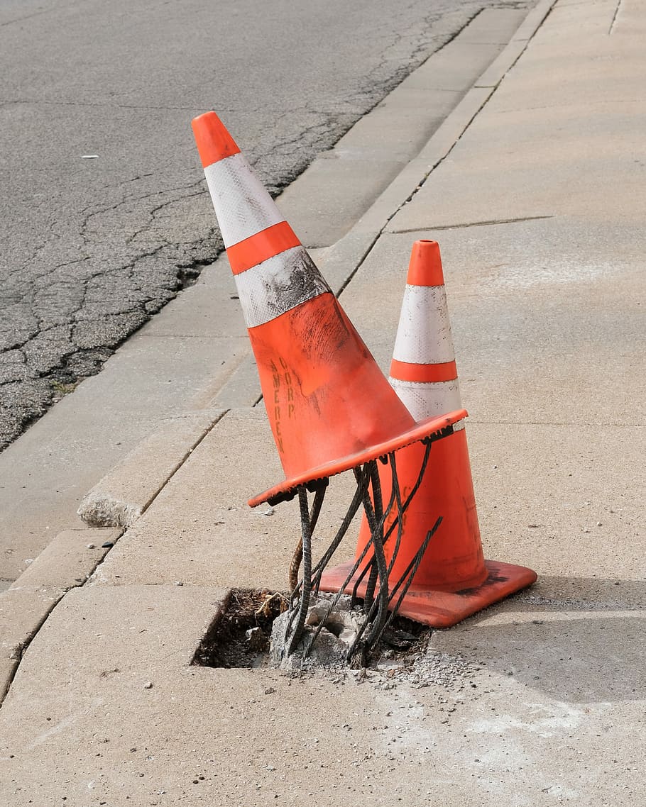910x1138 HD wallpaper: two traffic cones on gray road, two orange traffic cones on concrete curb