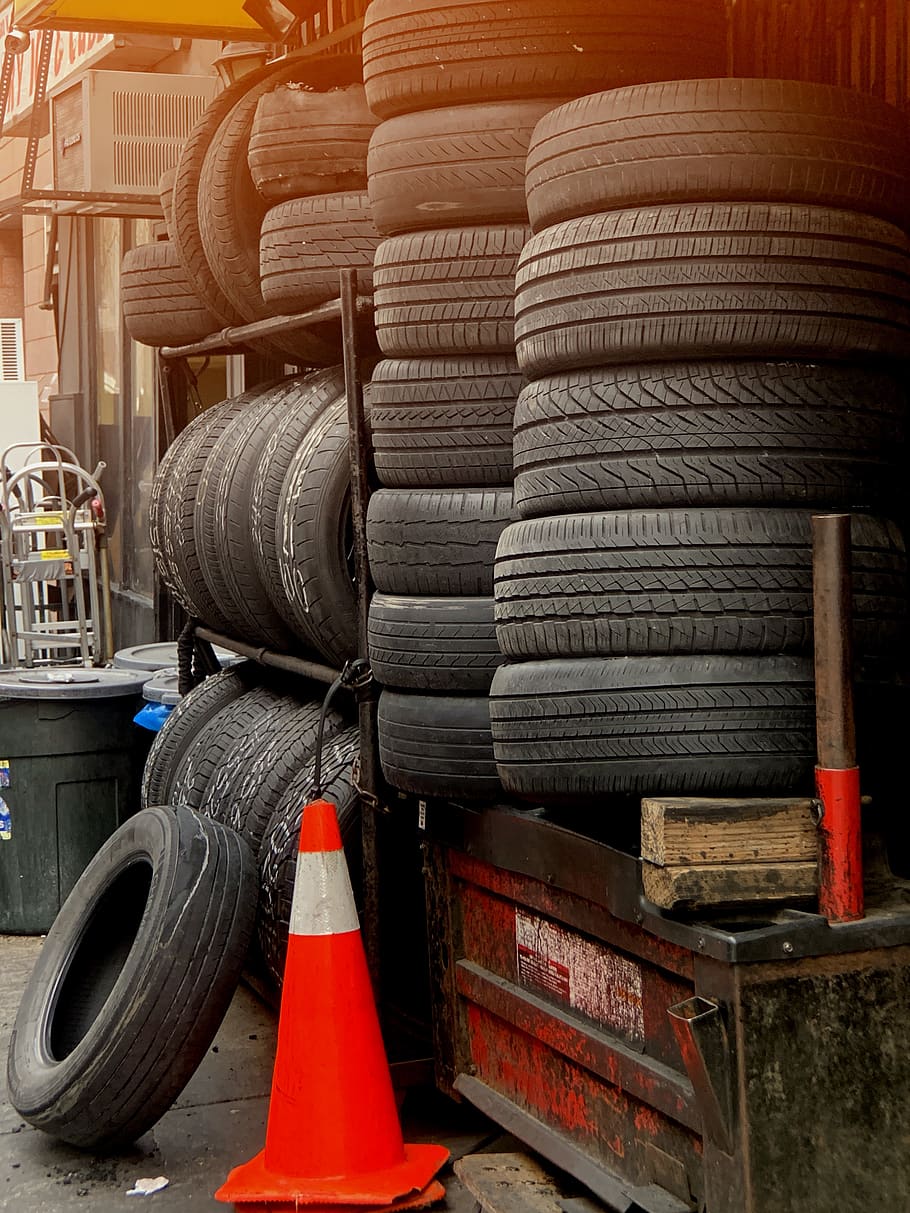 910x1213 HD wallpaper: orange traffic cone near pile of vehicle tires, stack, large group of objects