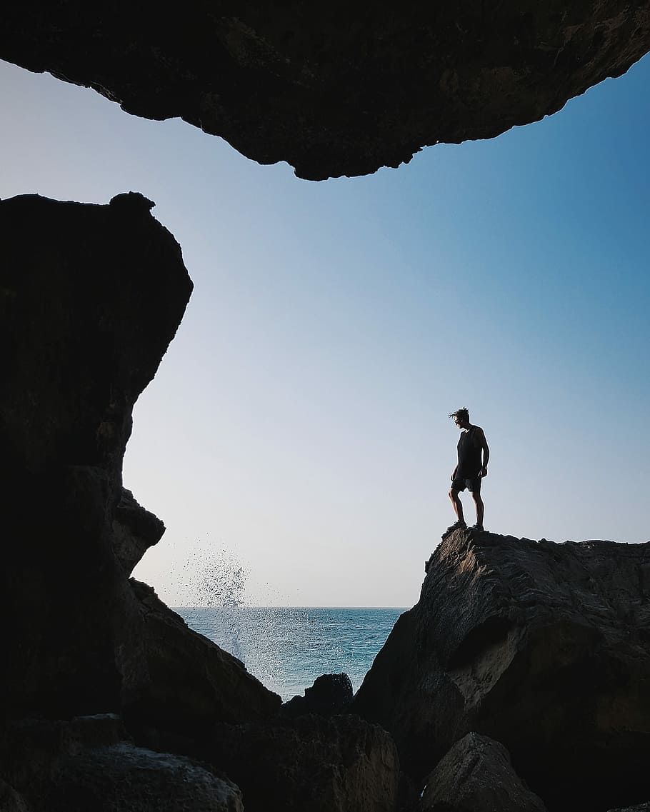 910x1137 HD wallpaper: man standing near body of water at daytime, rule of thirds photography of man standing on stone formation