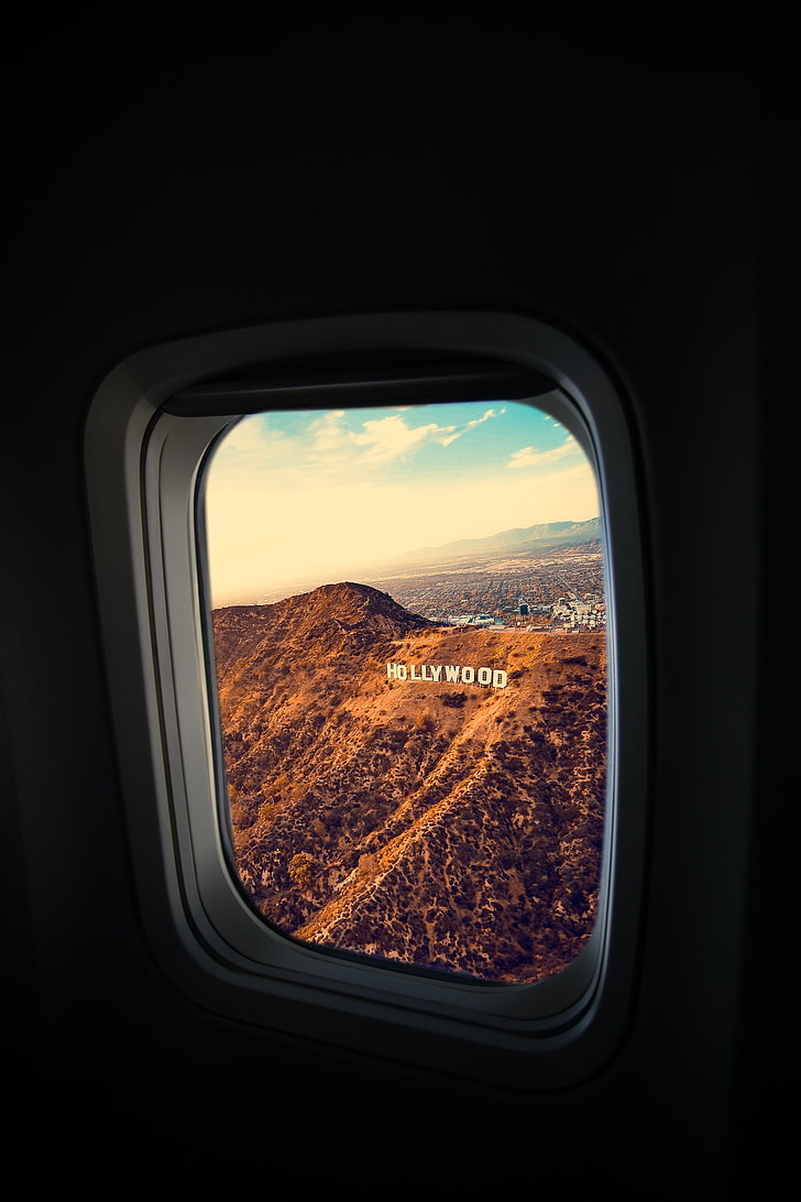 728x1092 HD wallpaper: Hollywood signage, porthole, window, plane, flight, los angeles