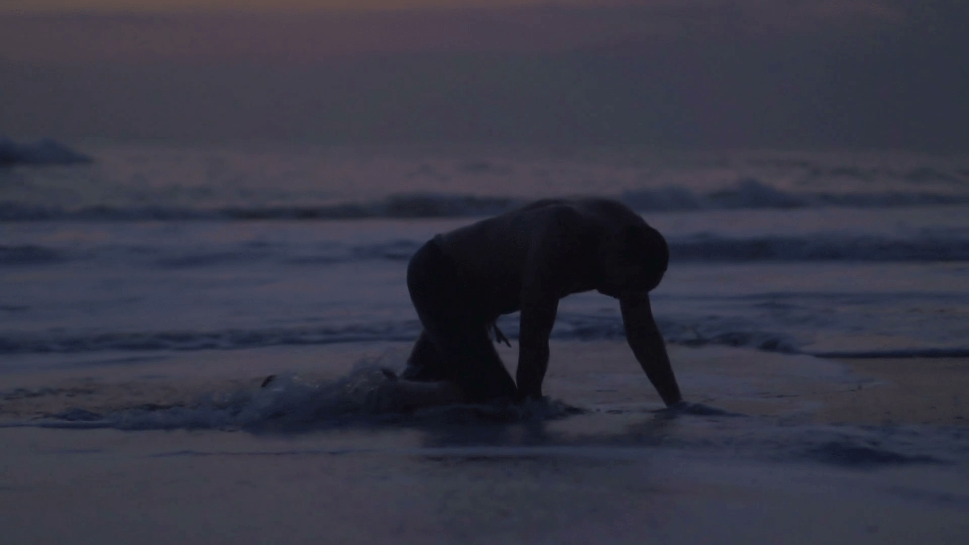 1920x1080 Tired man crawling on the beach, steadycam shot, slow motion shot