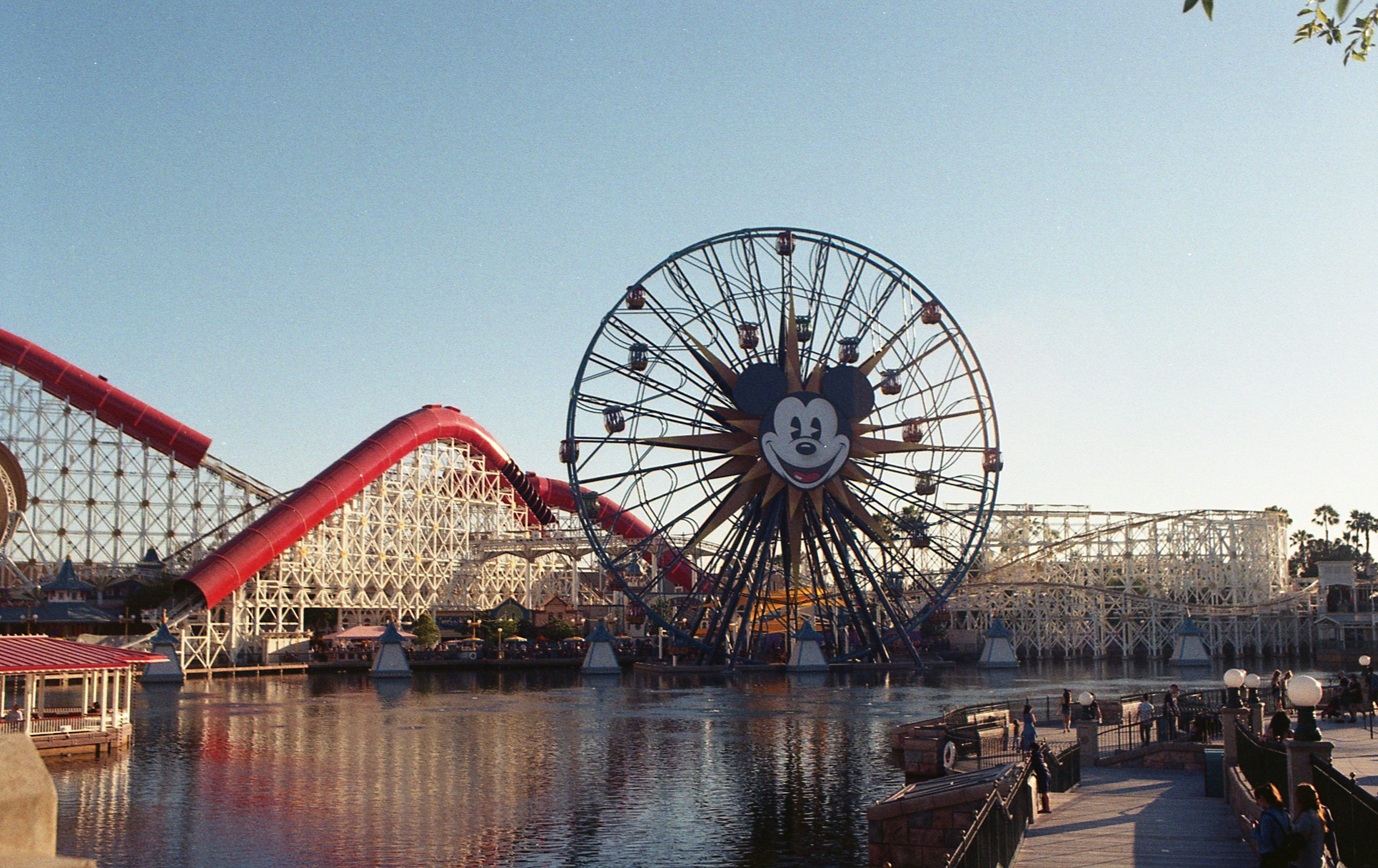 3000x1890 Pixar pier amusement park with roller coaster and lake