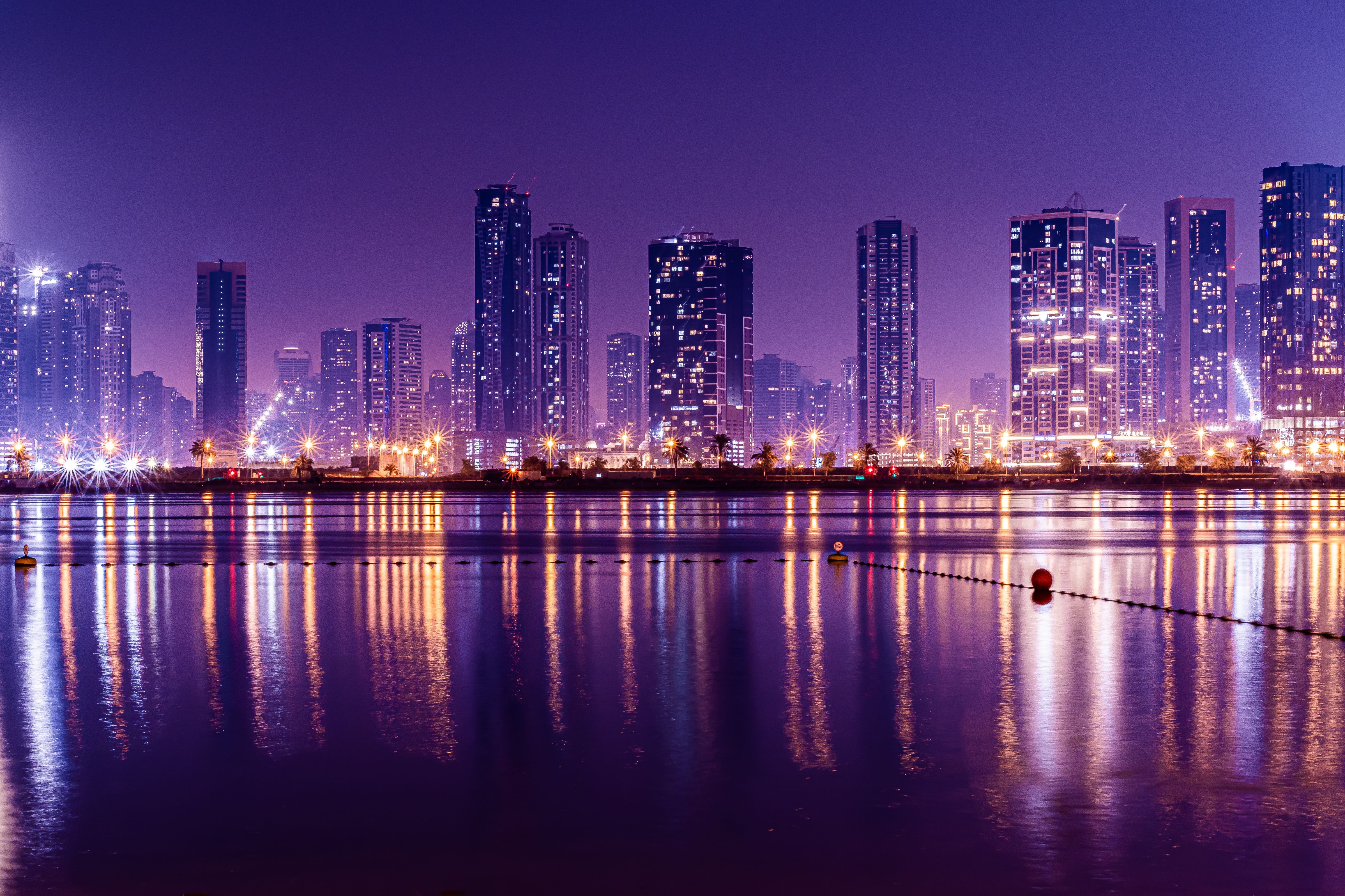 5964x3976 A city skyline at night with purple lights · Free