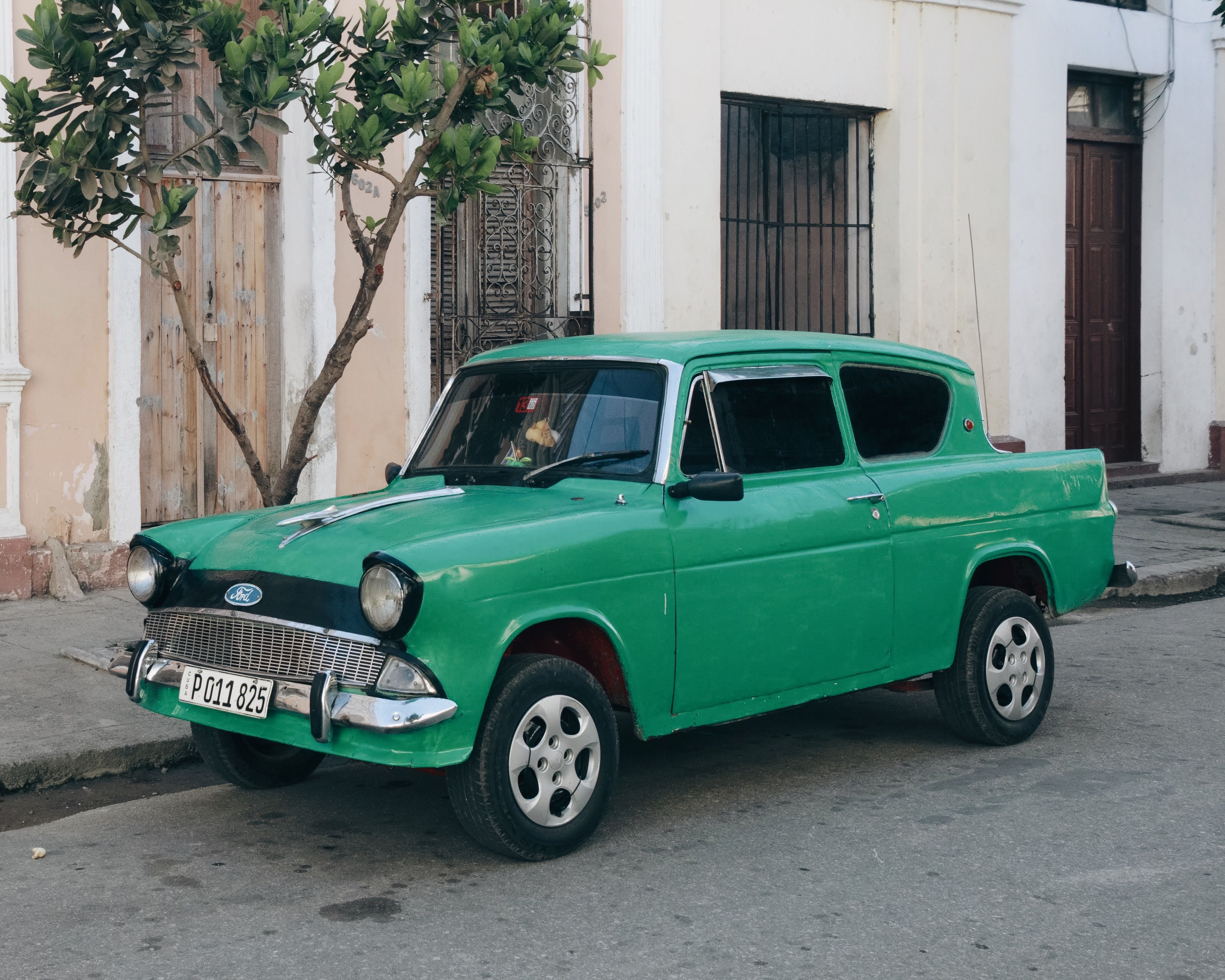 4080x3264 A Vintage Green Ford Anglia Parked on the Side of the Street · Free