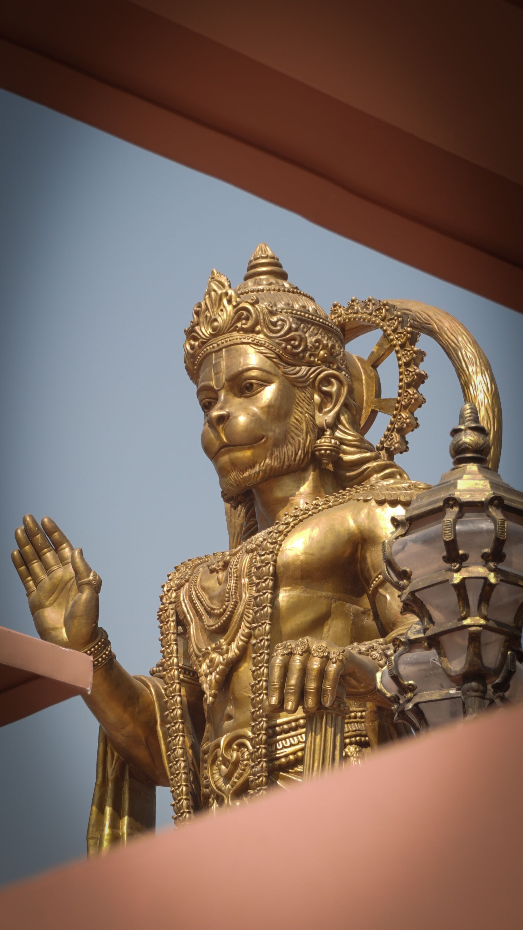 1692x3008 Majestic Golden Statue of Hanuman in Sunlight · Free