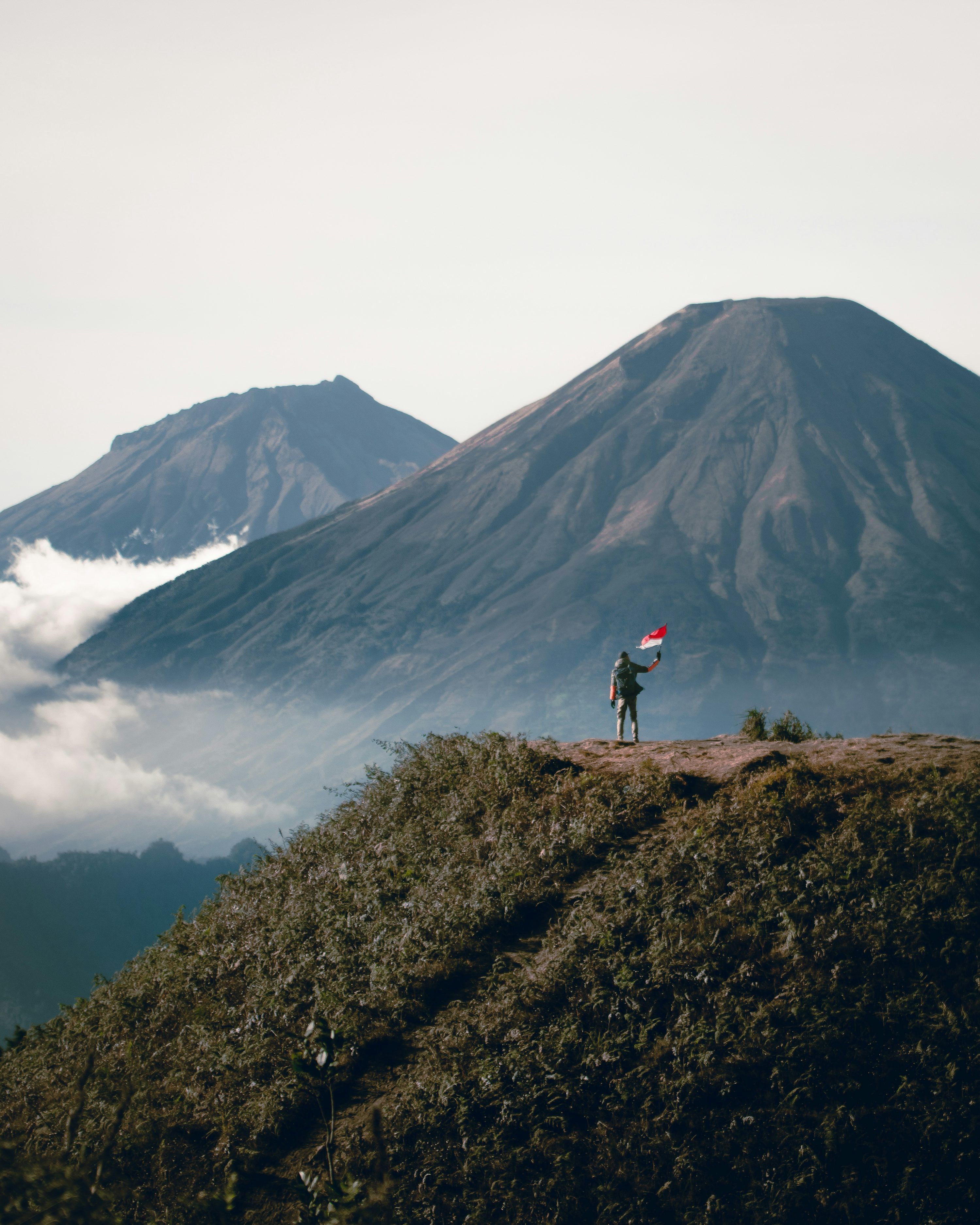 3000x3751 Person standing on cliff viewing mountain during daytime