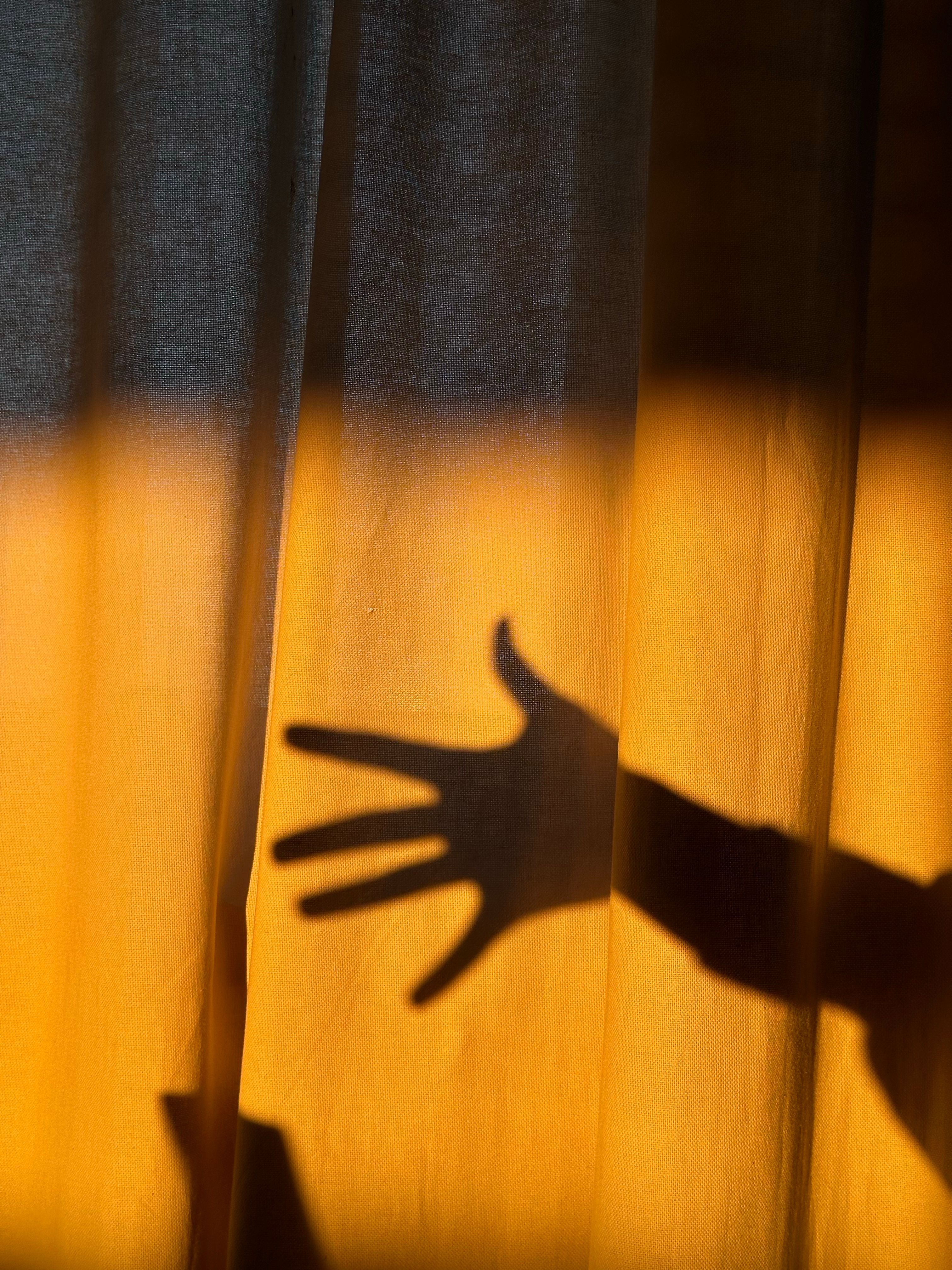 3024x4032 Silhouette of Hand Behind Yellow Curtain · Free