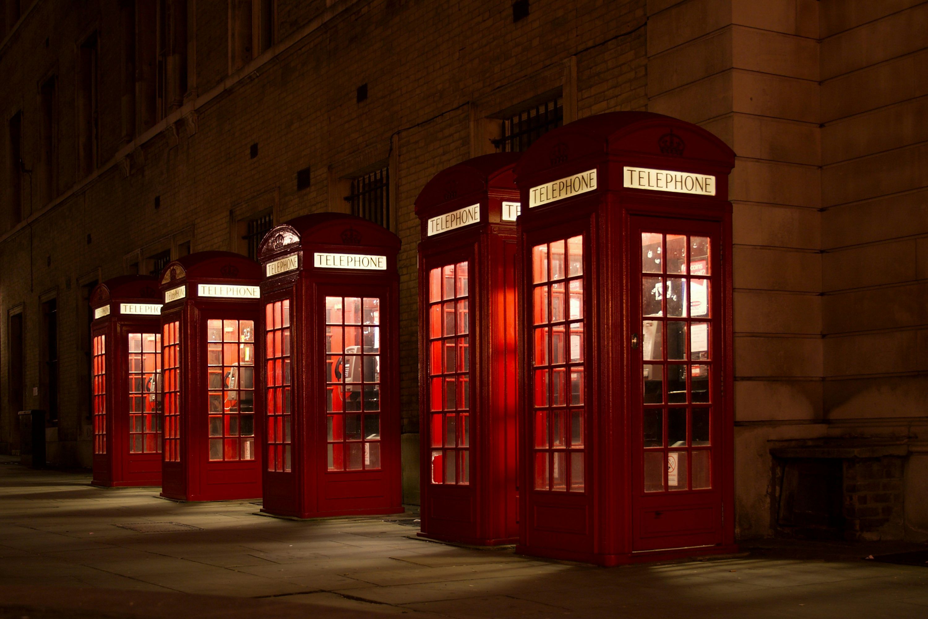 3000x2001 Red london post boxes on wet city street at night