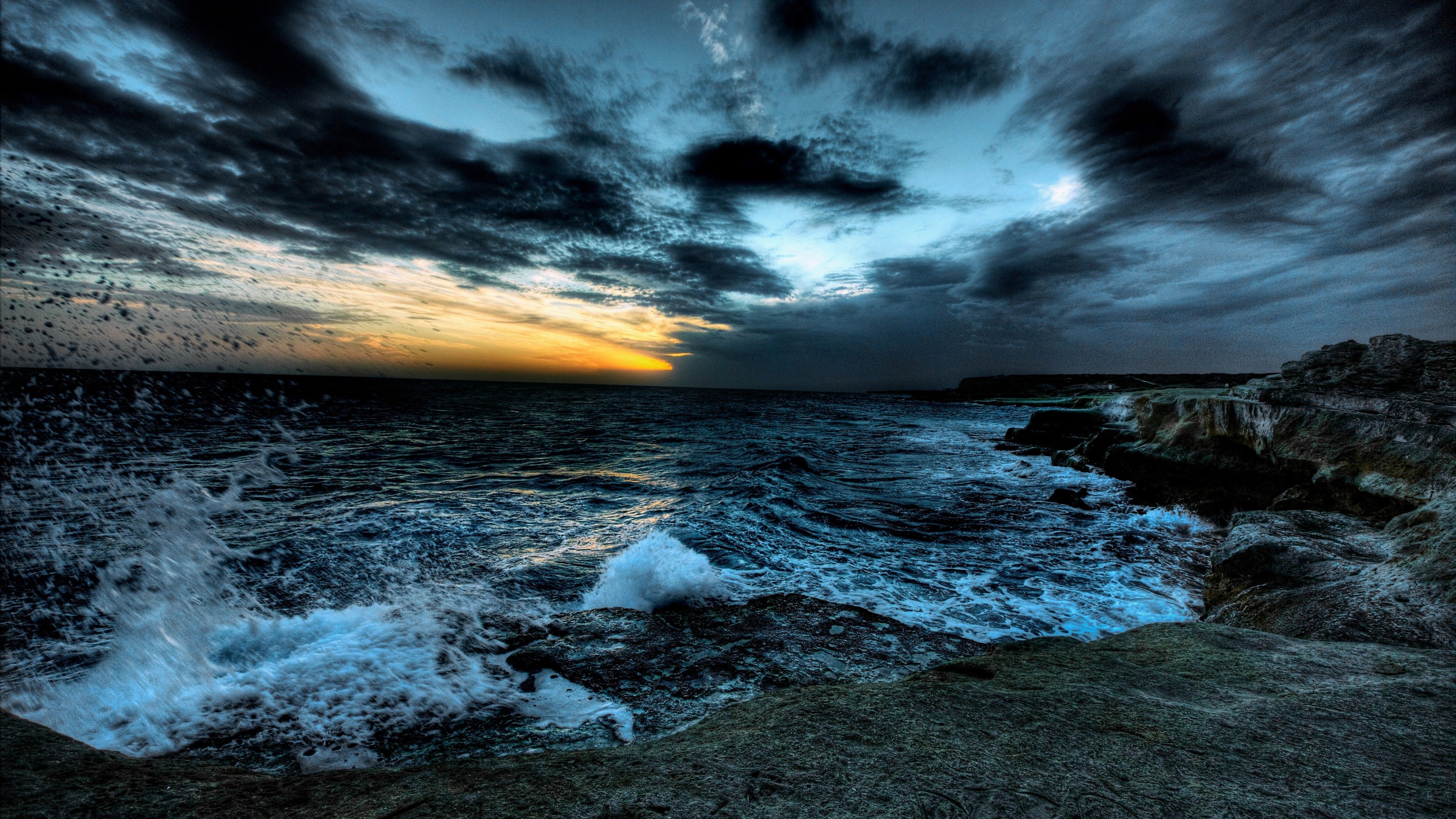 3840x2160 rough sea under dark clouds sky rocks ocean waves splash during sunset 4K 5K HD Nature Wallpaper