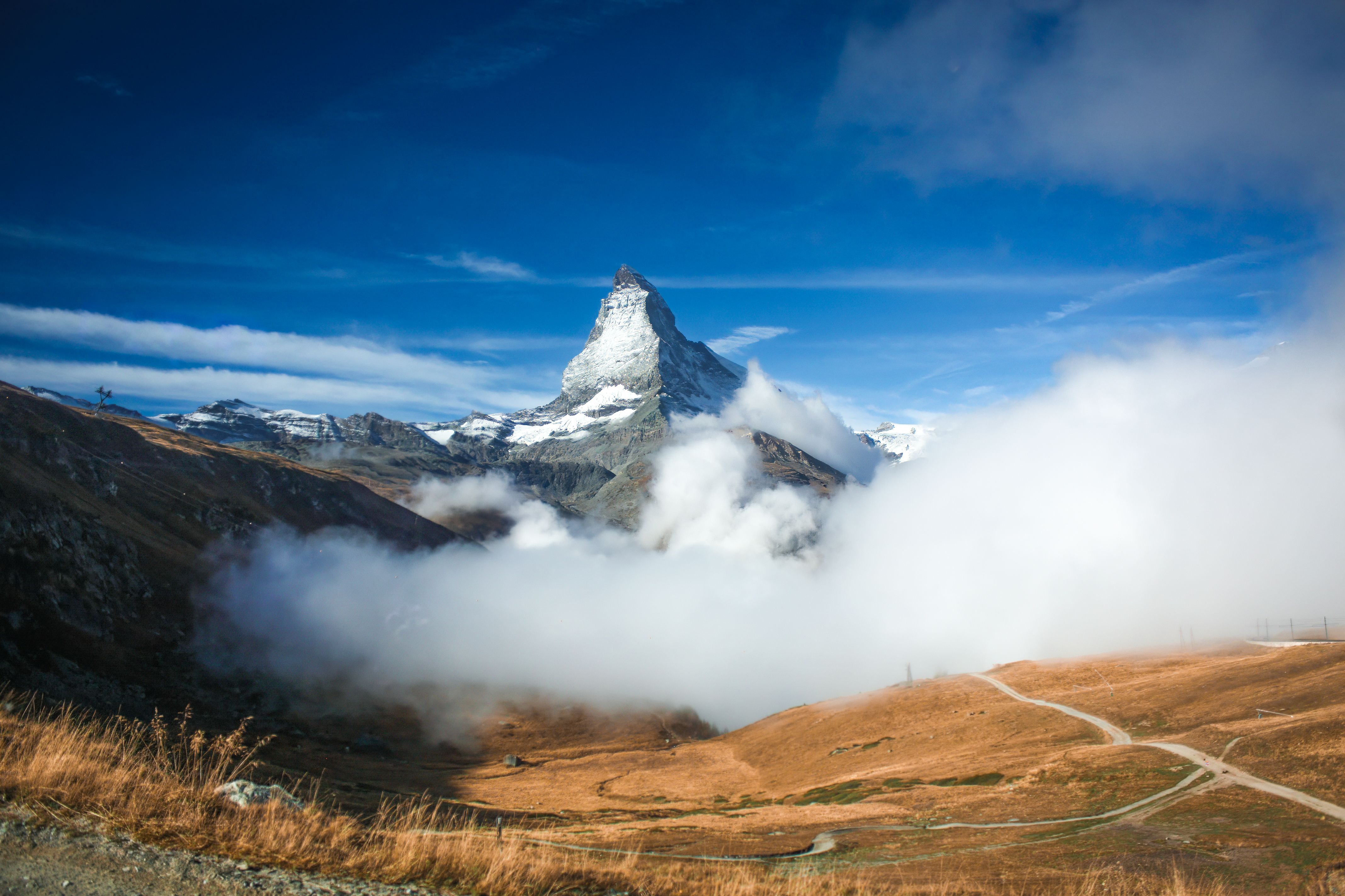 4272x2848 Scenic View of a Cloud over a Valley and the Matterhorn Mountain on the Border of Italy and Switzerland · Free