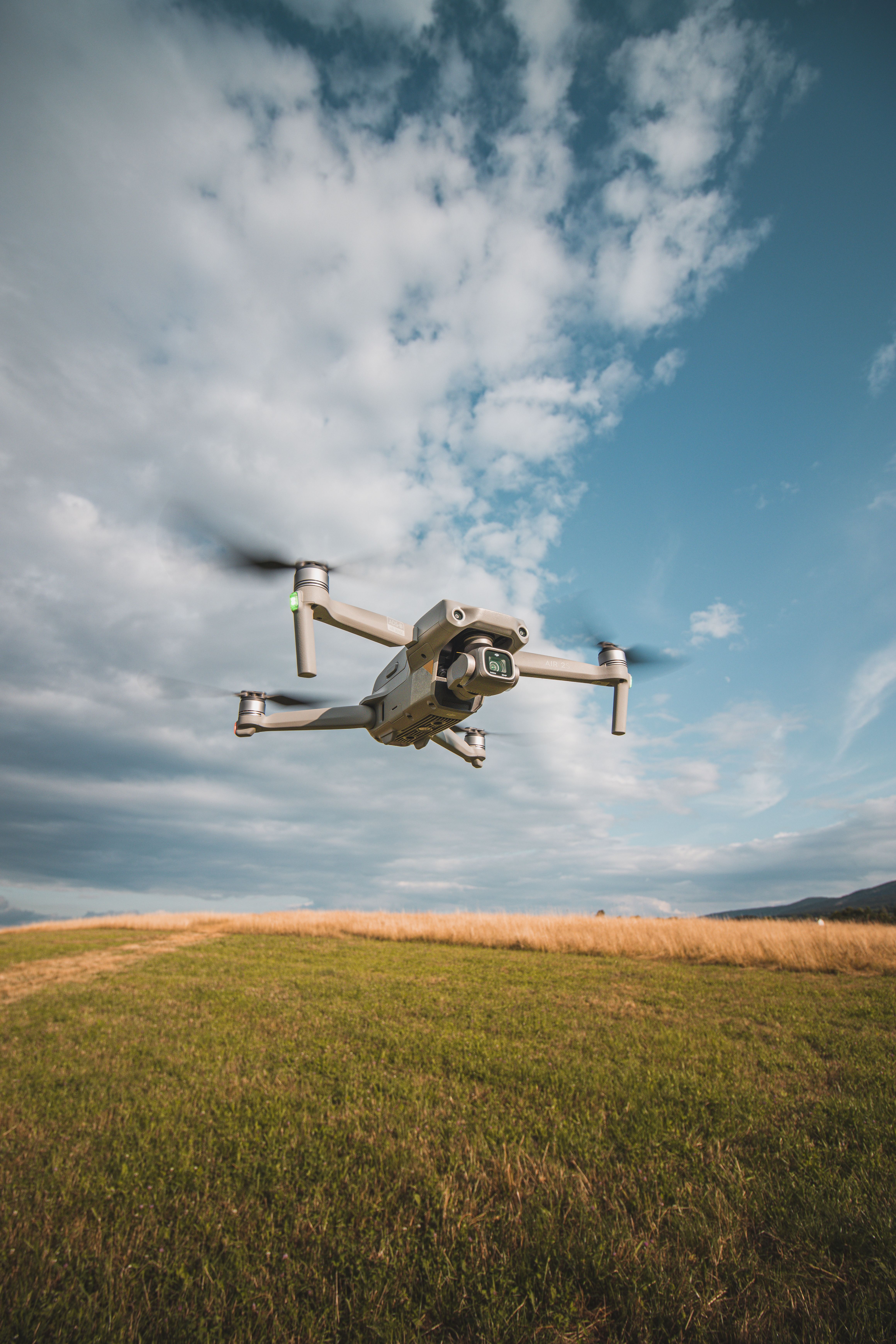 4640x6960 DJI Mavic Air 2 Drone Hovering Over a Field · Free