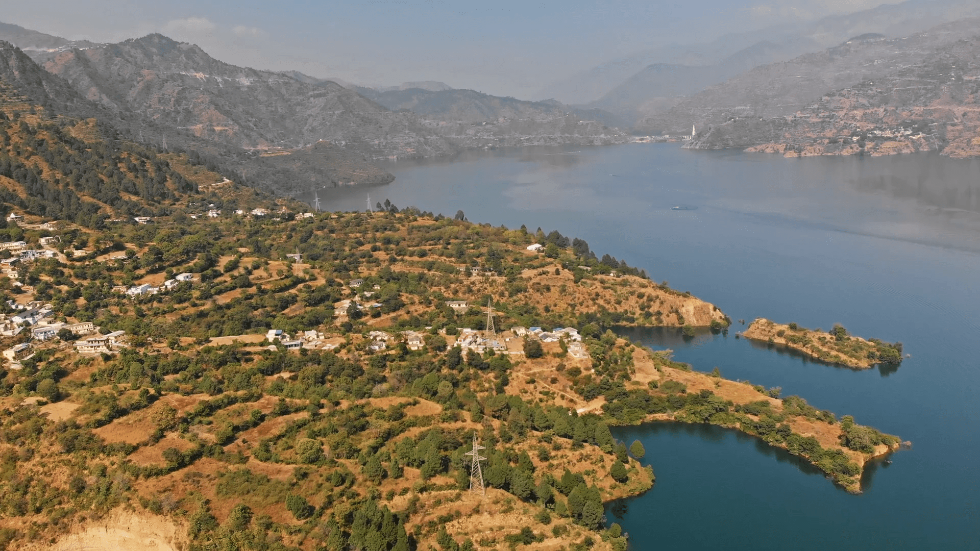1920x1080 Aerial Drone View Of Tehri Dam, The Tallest Dam In India, A Multi Purpose Rock And Earth Fill Embankment Dam On The Bhagirathi River Near Tehri In Uttarakhand, India. Village Situated On The Riverside