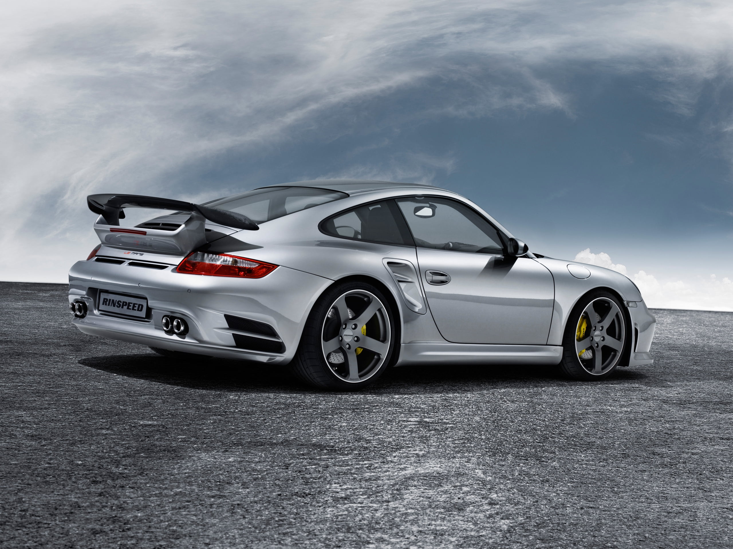 2560x1920 Silver and black coupe with spoiler parked on grey pavement HD wallpaper