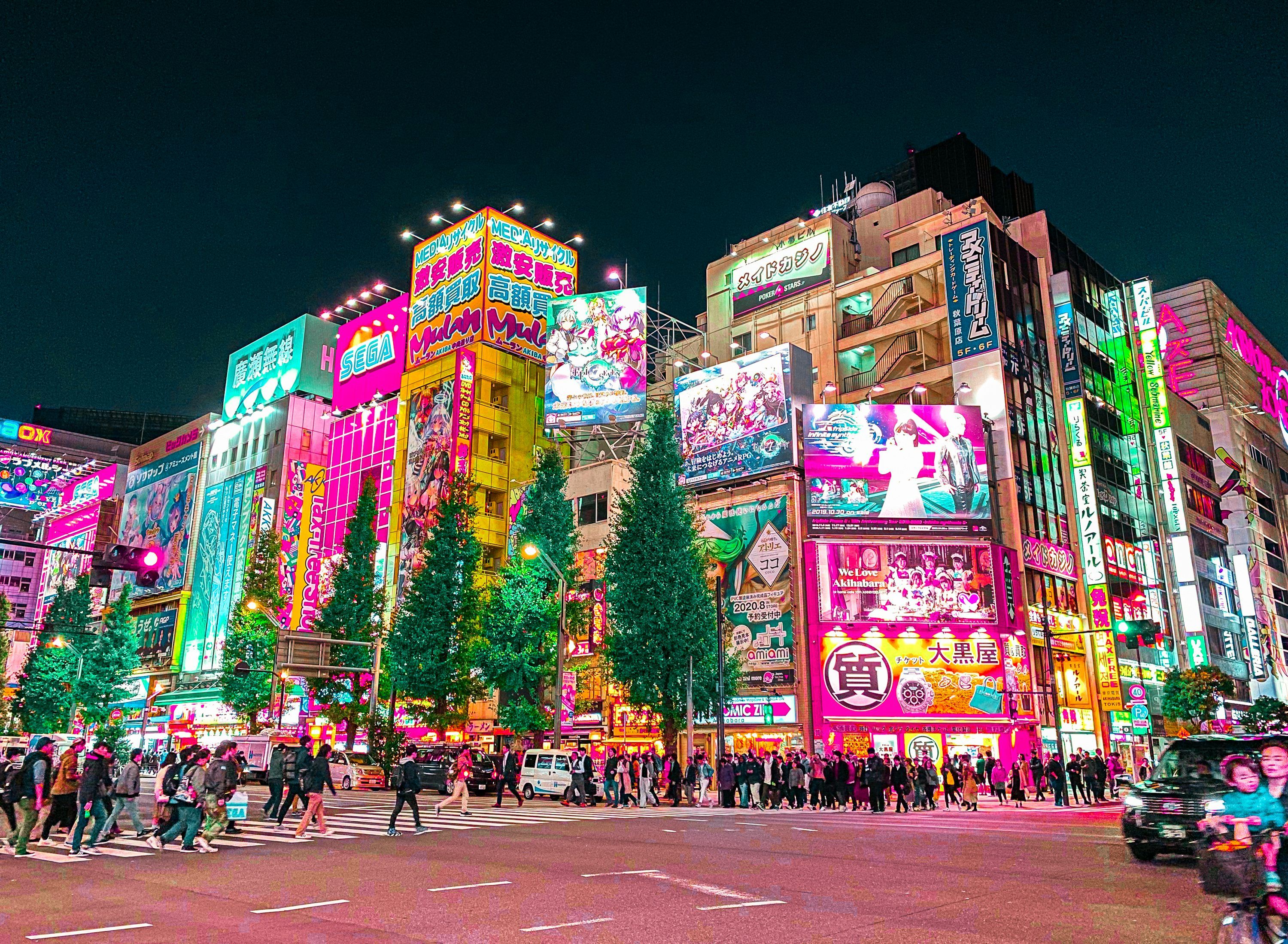 3000x2199 A group of people walking around a city at night