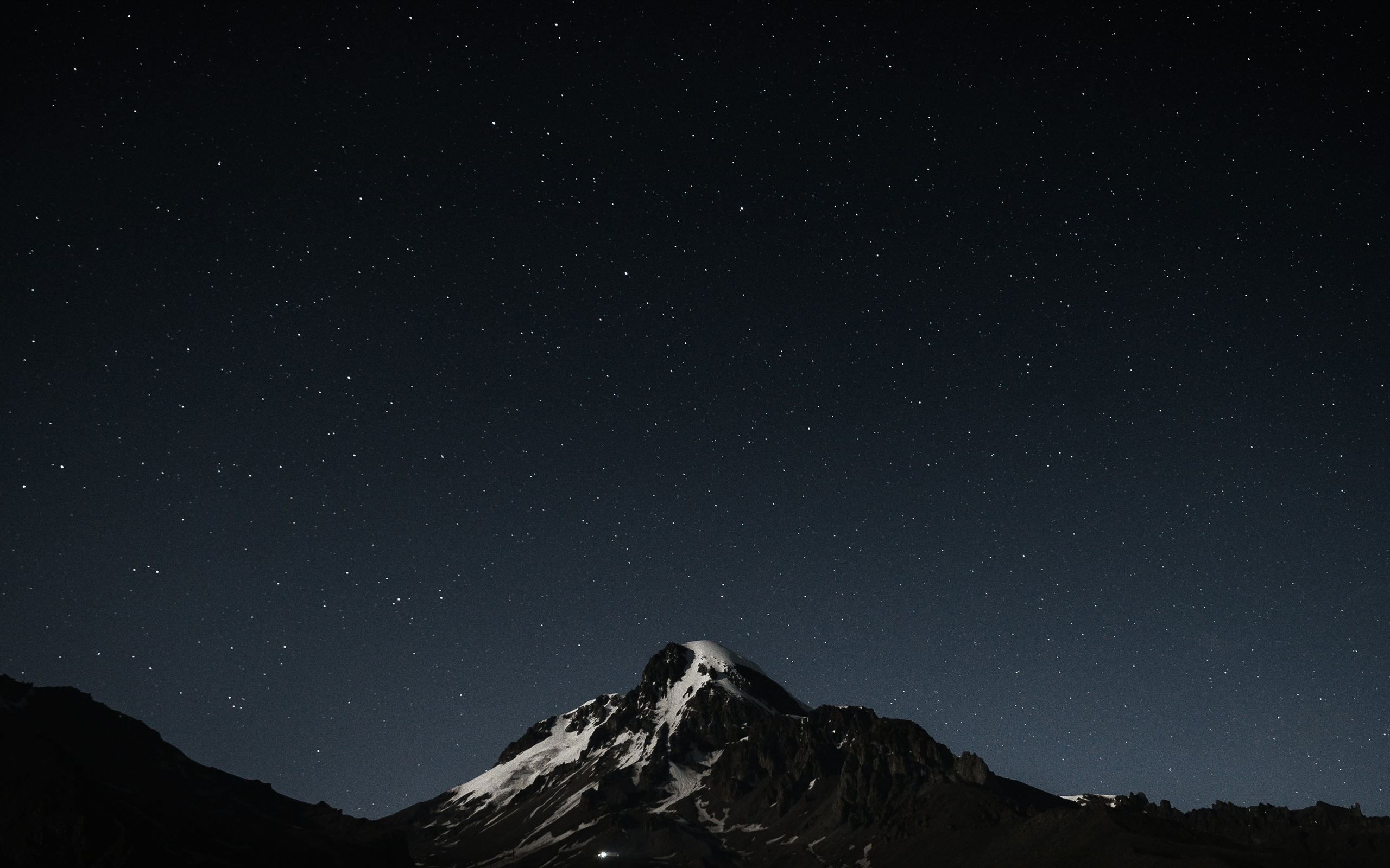 2560x1600 The night sky with stars above a mountain MacBook Air Wallpaper Download