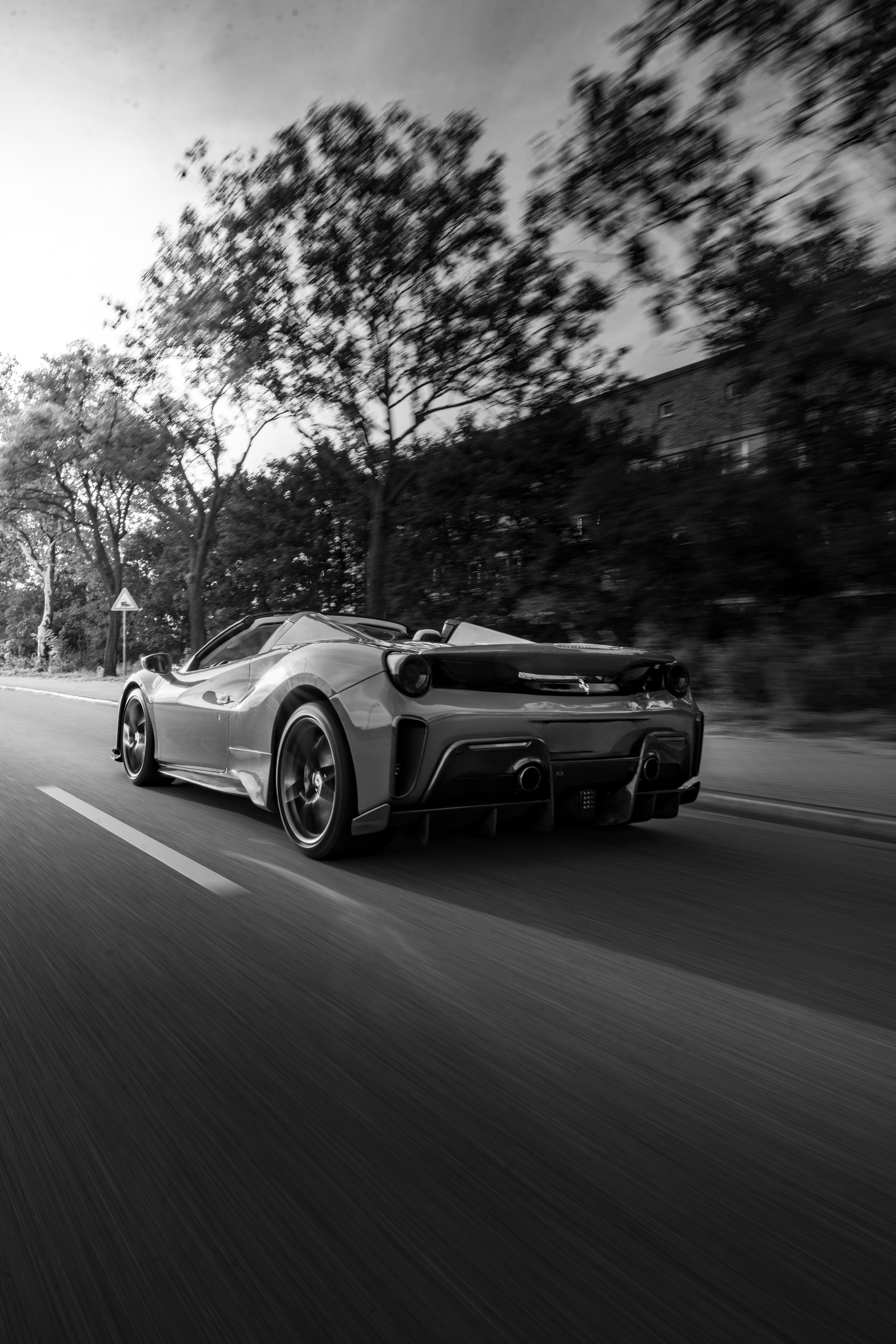 4672x7008 Sleek Ferrari on Scenic Urban Roadway · Free
