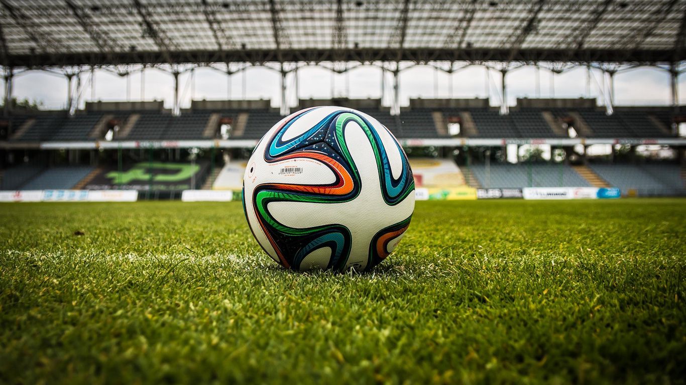 1366x768 Download wallpaper 1366x768 ball, football, lawn, stadium tablet, laptop HD background