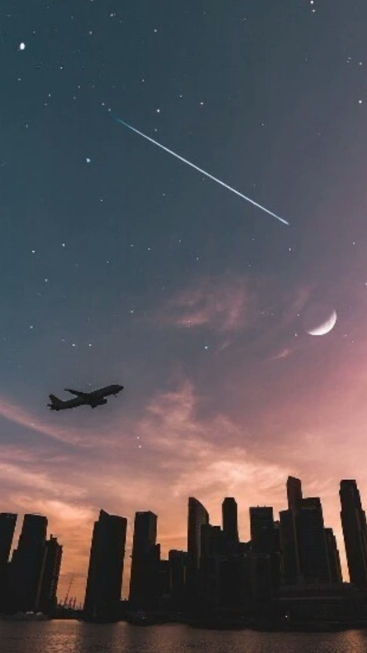 736x1308 Airplane Wallpaper with Moon and Stars. Airplane flying over city skyline at night, Moonlit urban skyline, Photography ideas for urban landscapes