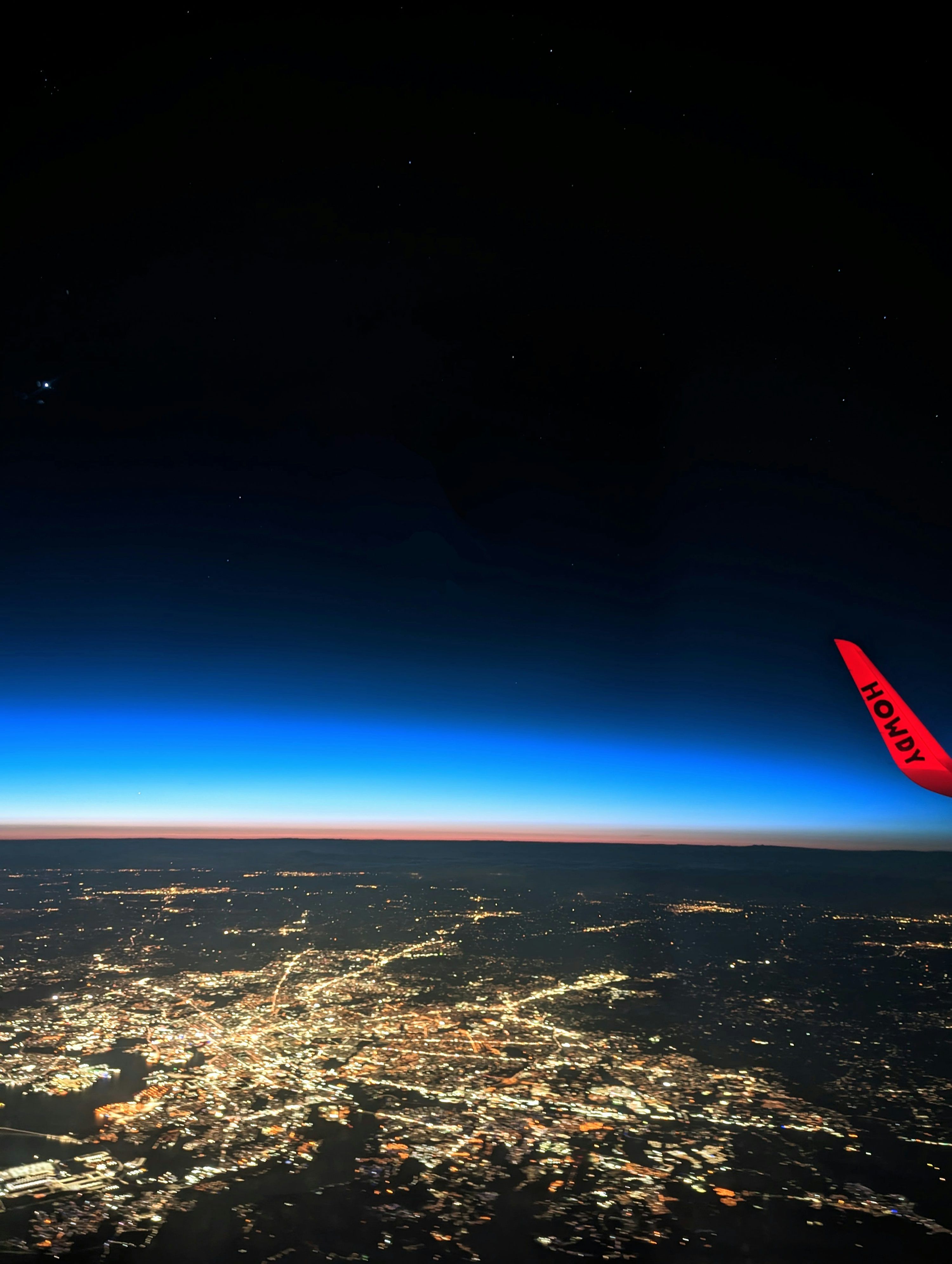 3000x3984 A view of a city at night from an airplane