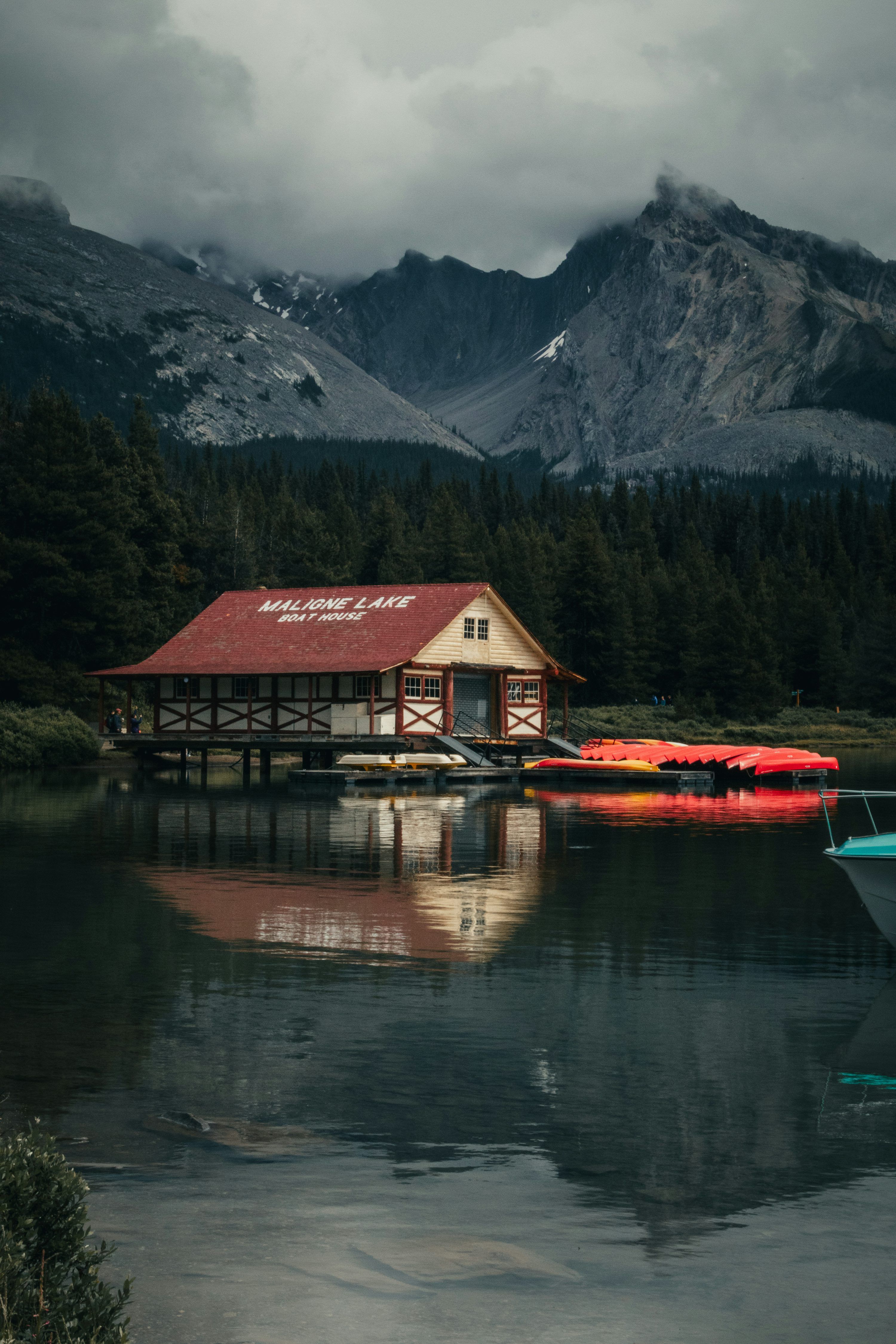 3000x4500 Boathouse on a calm lake with mountains and forest