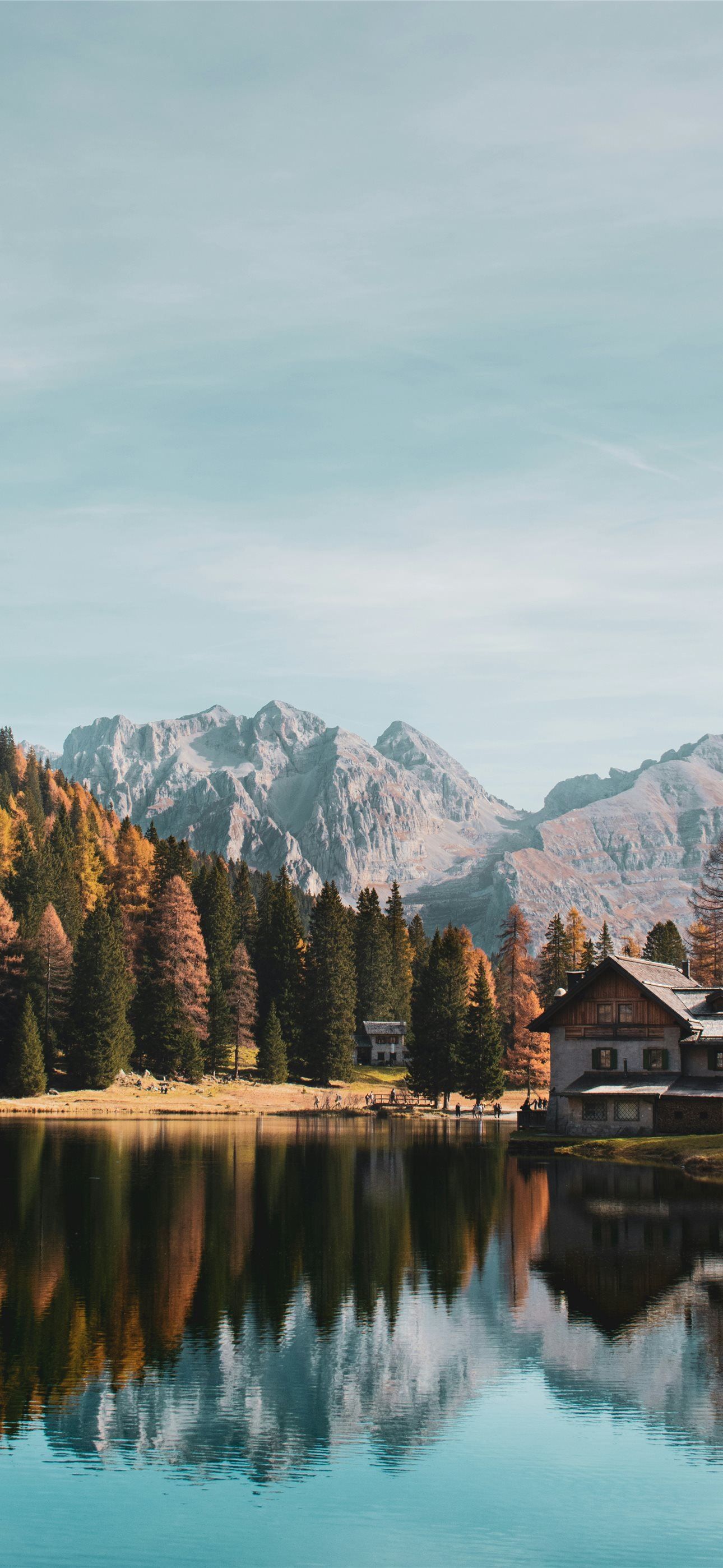 1290x2796 a house by a lake with mountains in the background iPhone Wallpaper Free Download