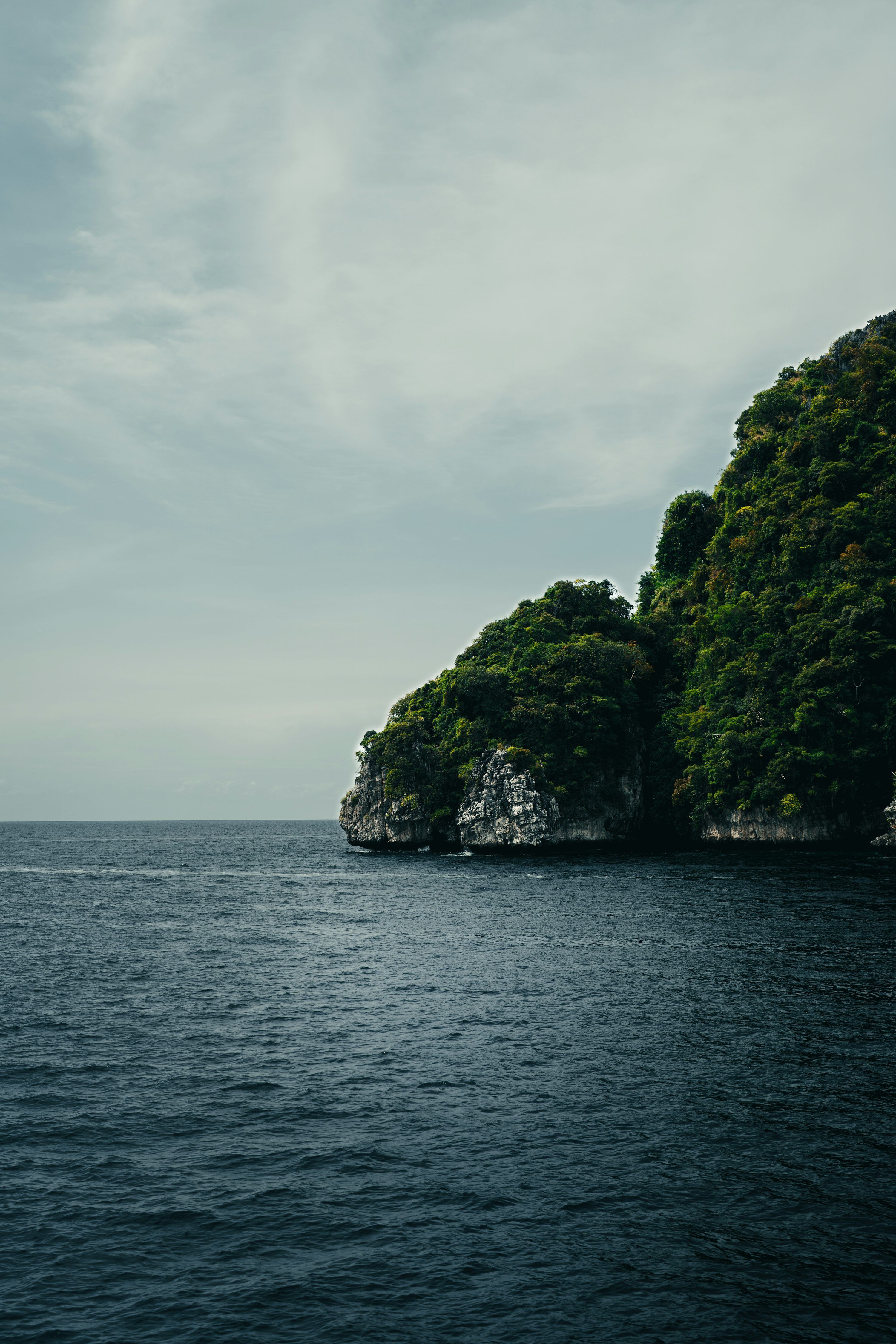 3000x4500 A small island in the middle of a body of water