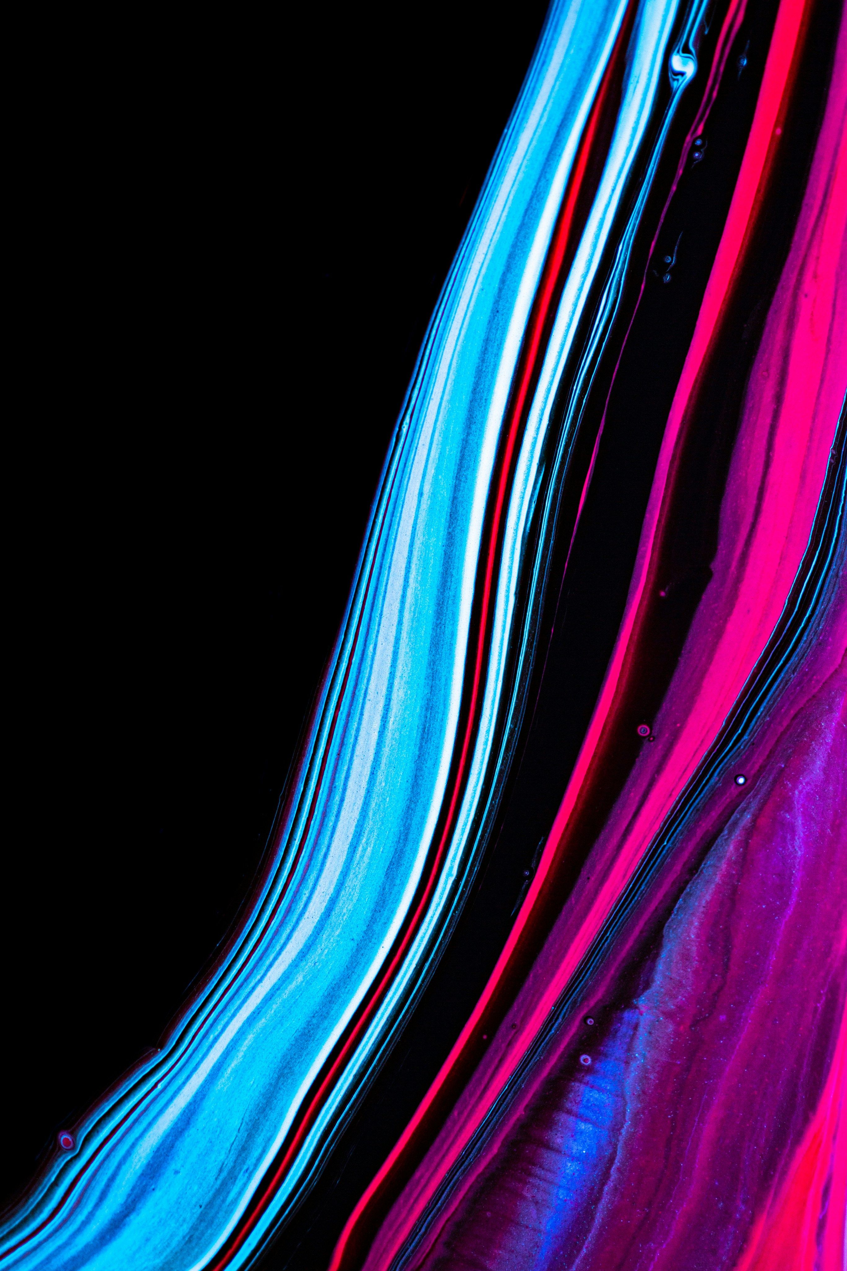 2733x4100 A black background with purple and blue liquid