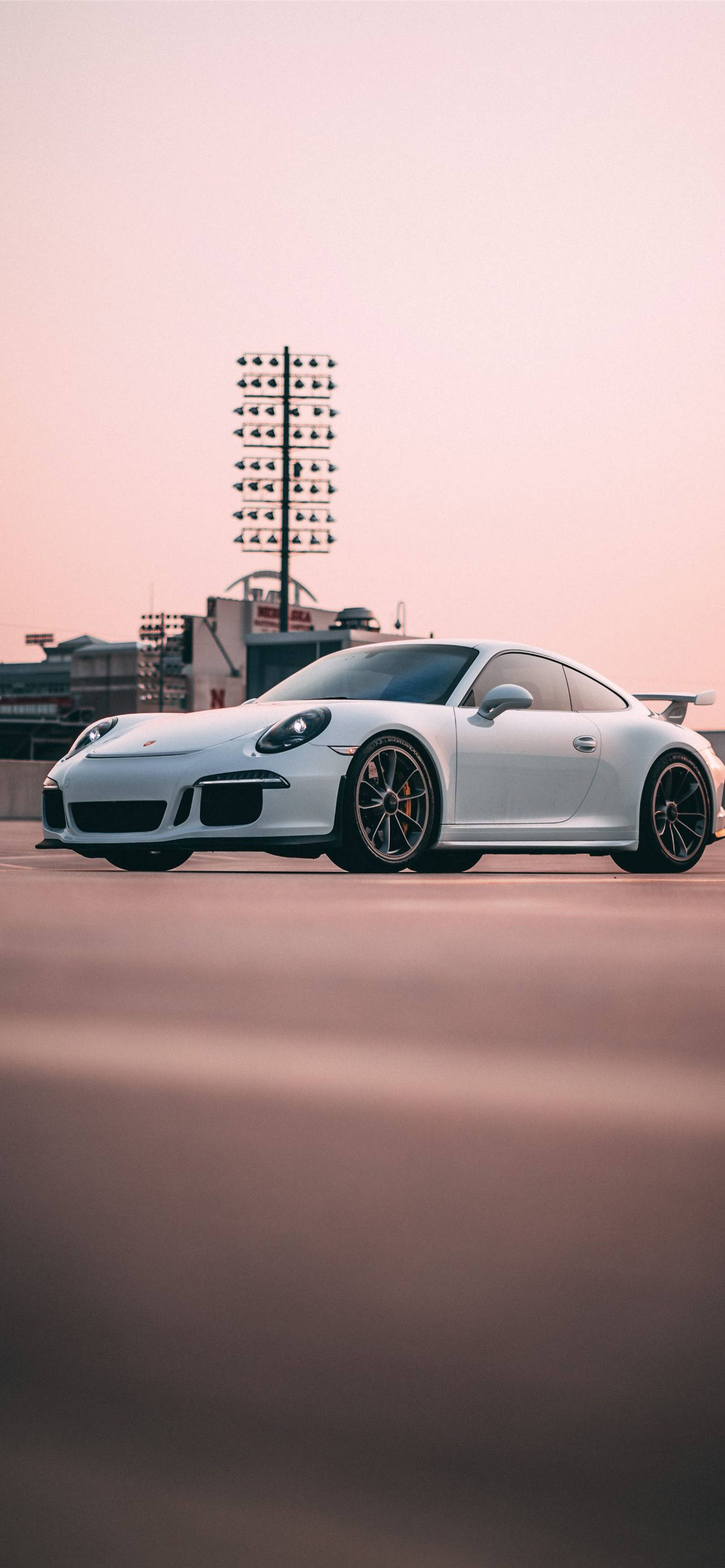 1284x2778 Download White Porsche 911 In Outdoor Parking Wallpaper