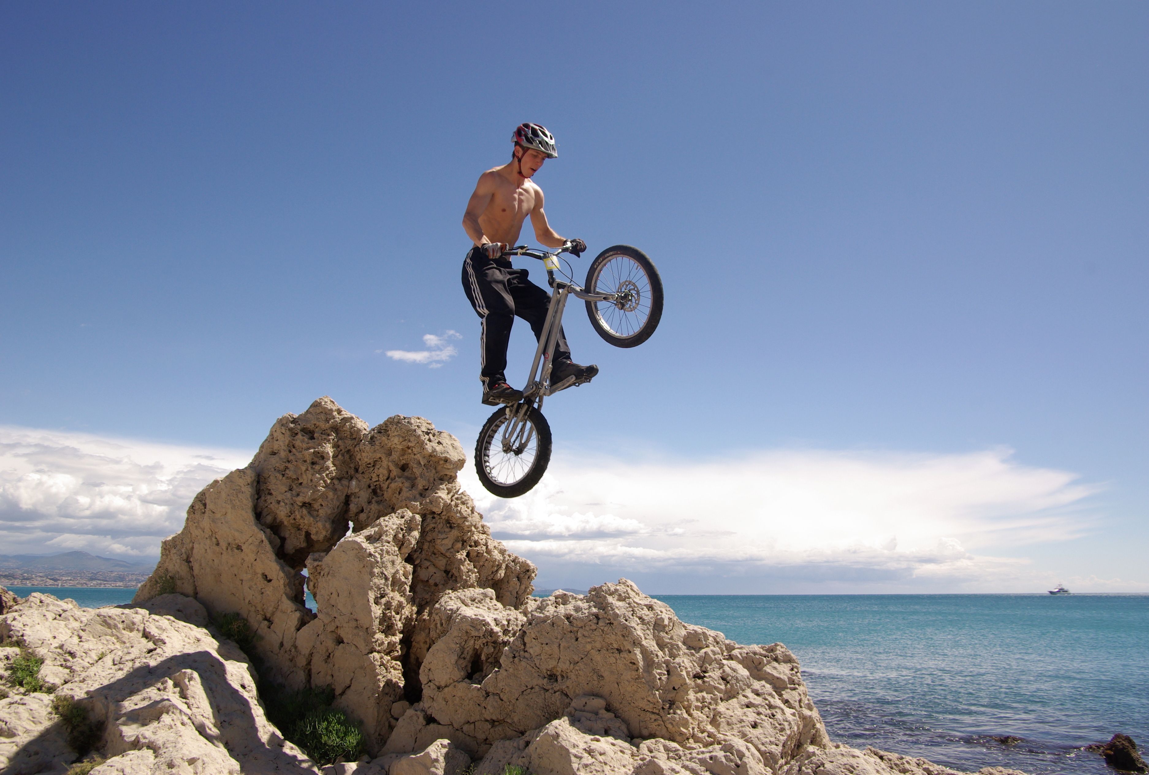 3749x2529 Cyclist Jumping on Rocks · Free