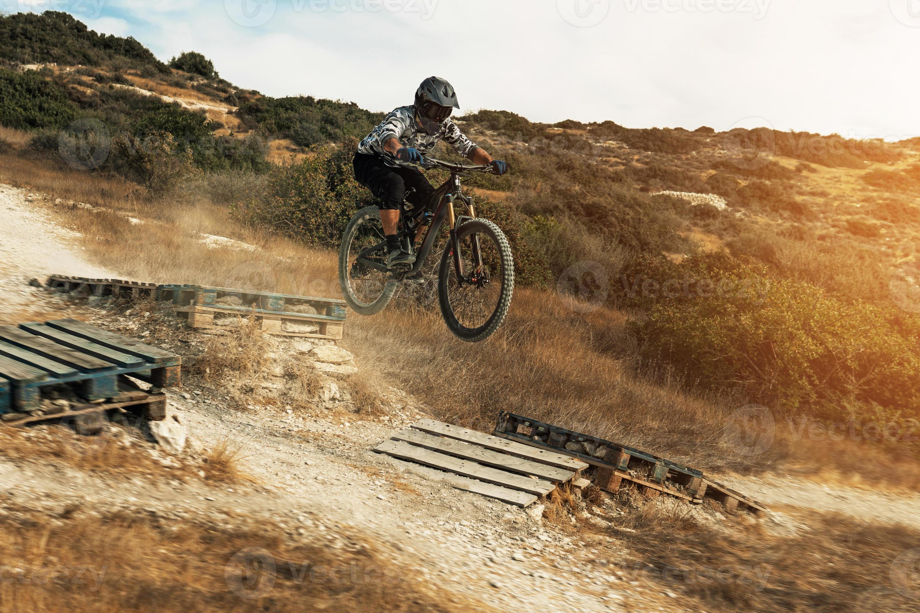 2941x1960 MTB bike rider jumping during downhill ride on his bicycle in mountains