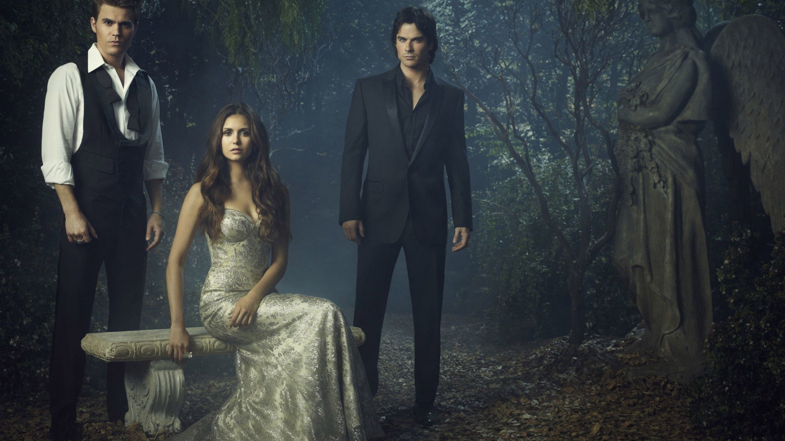 2560x1440 Damon Salvatore Stefan Salvatore Elena Gilbert With White Dress In Forest Background HD The Vampire Diaries Wallpaper